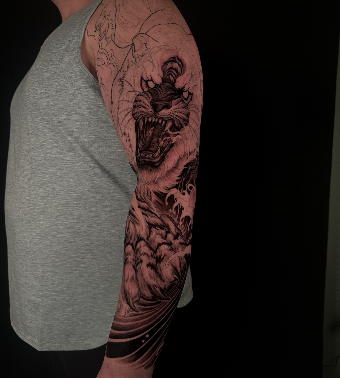 Roaring tiger realism tattoo on the forearm by Vince Lau