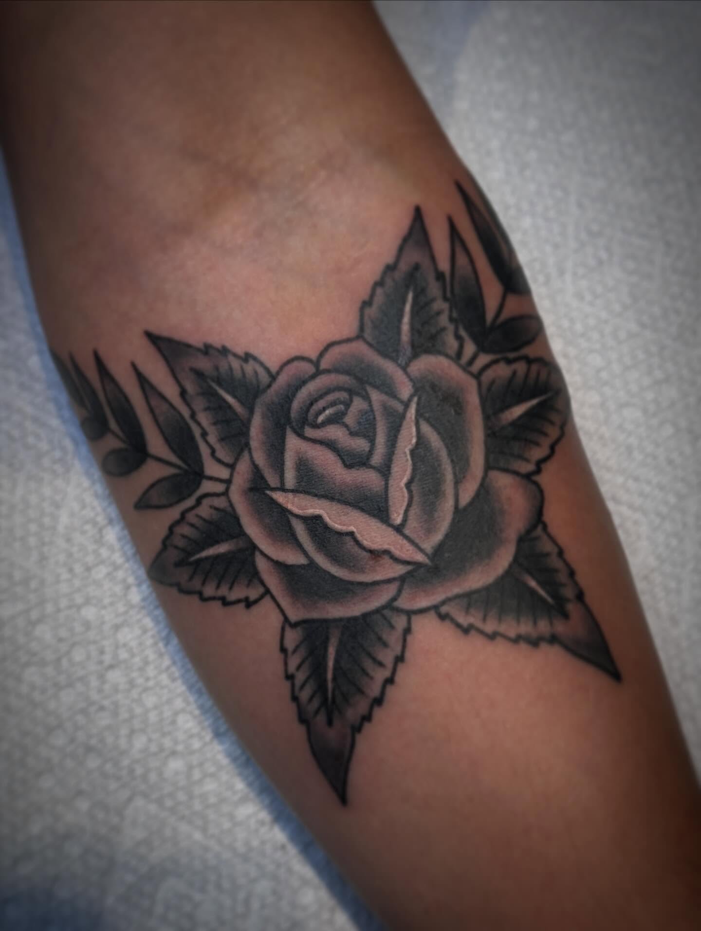 Rose American traditional tattoo on the forearm by Drew McElveney, Austin, Texas