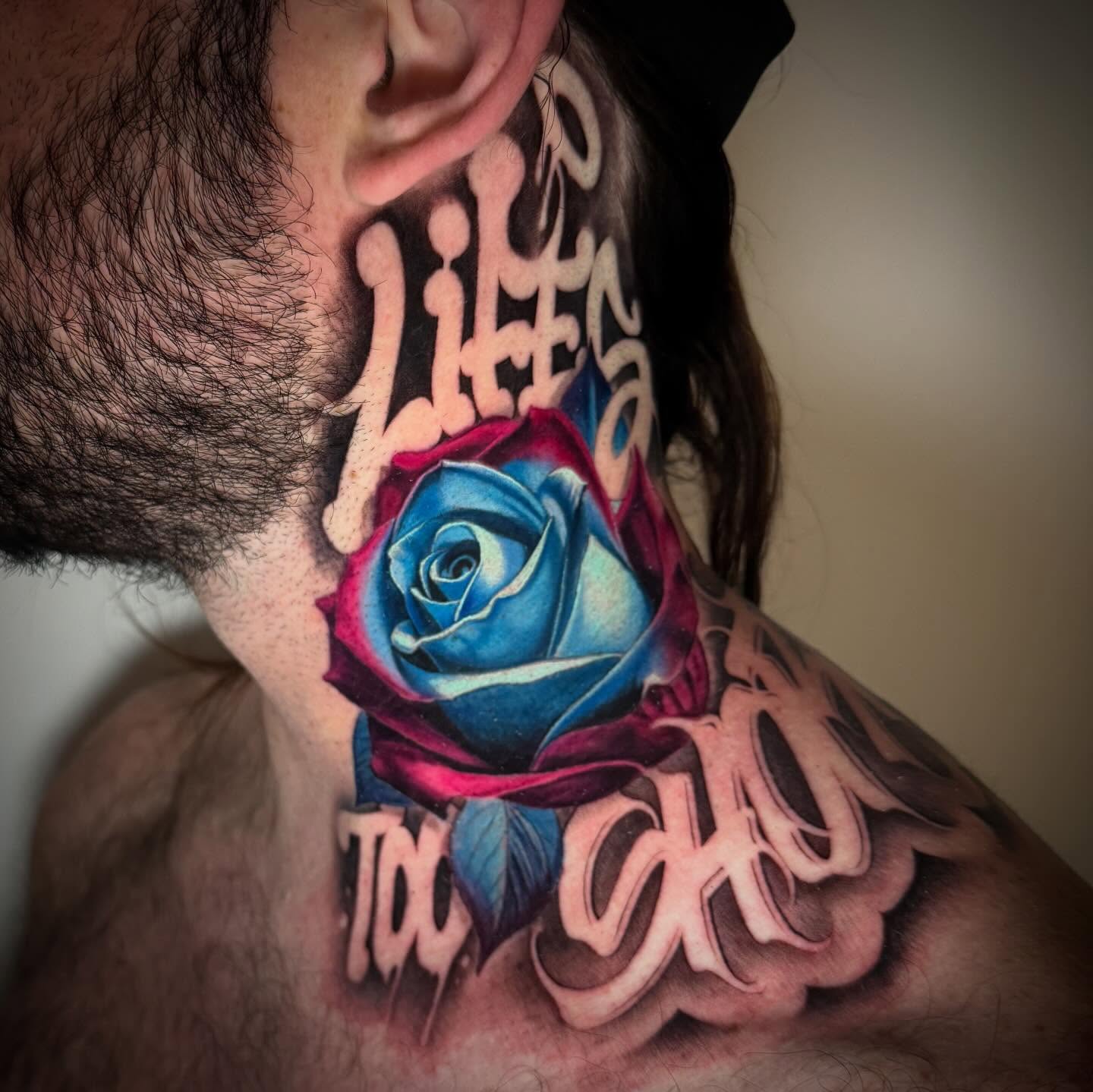 Blue rose realism tattoo on the neck by TJ Schunemann