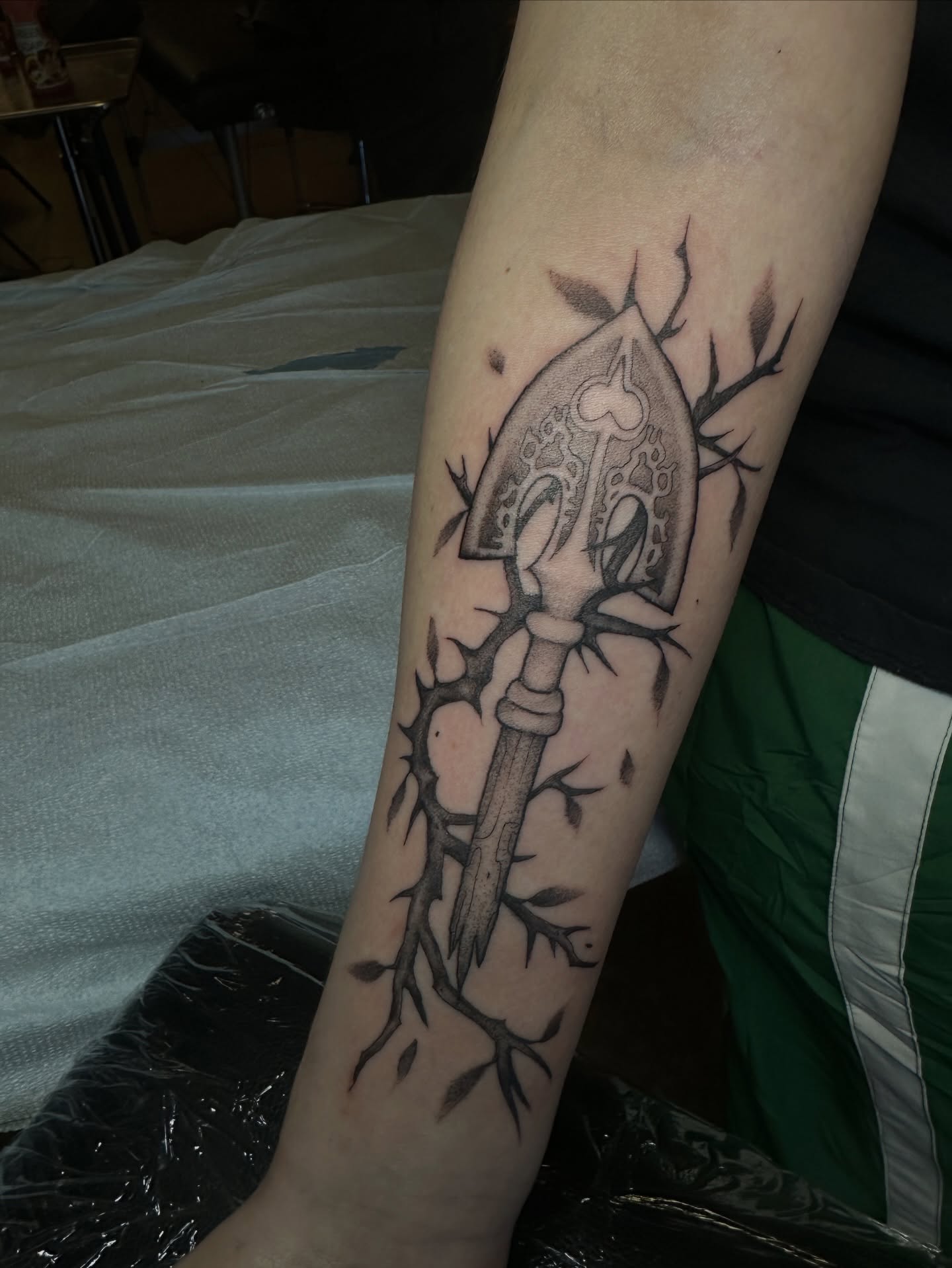 Spade and thorns black and grey tattoo on the forearm by Luisa Gonzalez, Austin, Texas