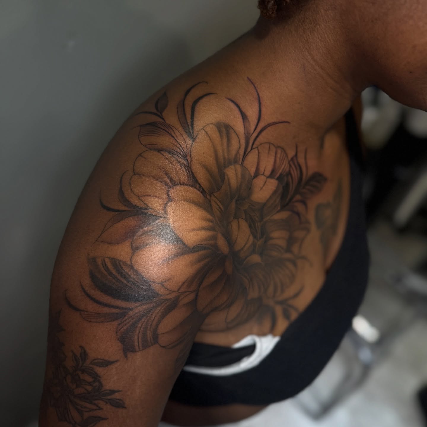 Flower black and grey tattoo on the shoulder by Visionary🌌