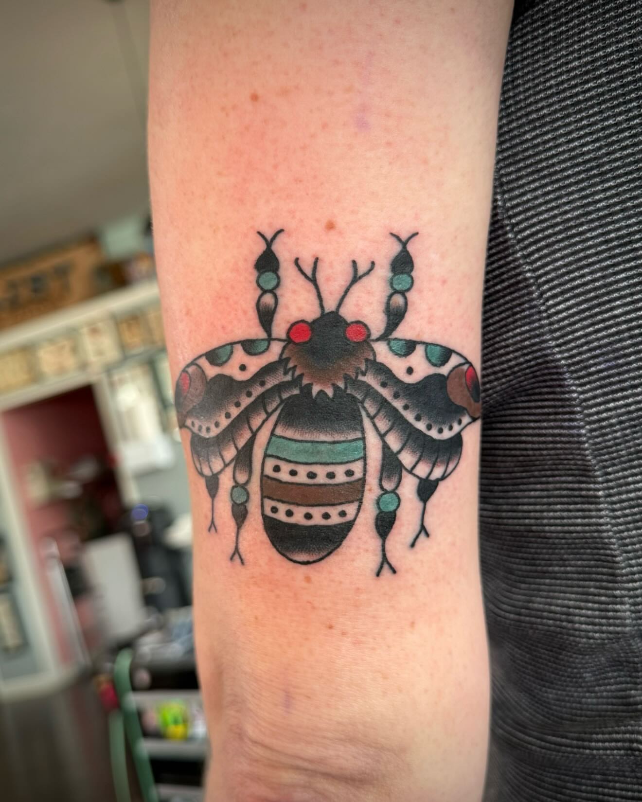 Bee American traditional tattoo on the forearm by kalli berry