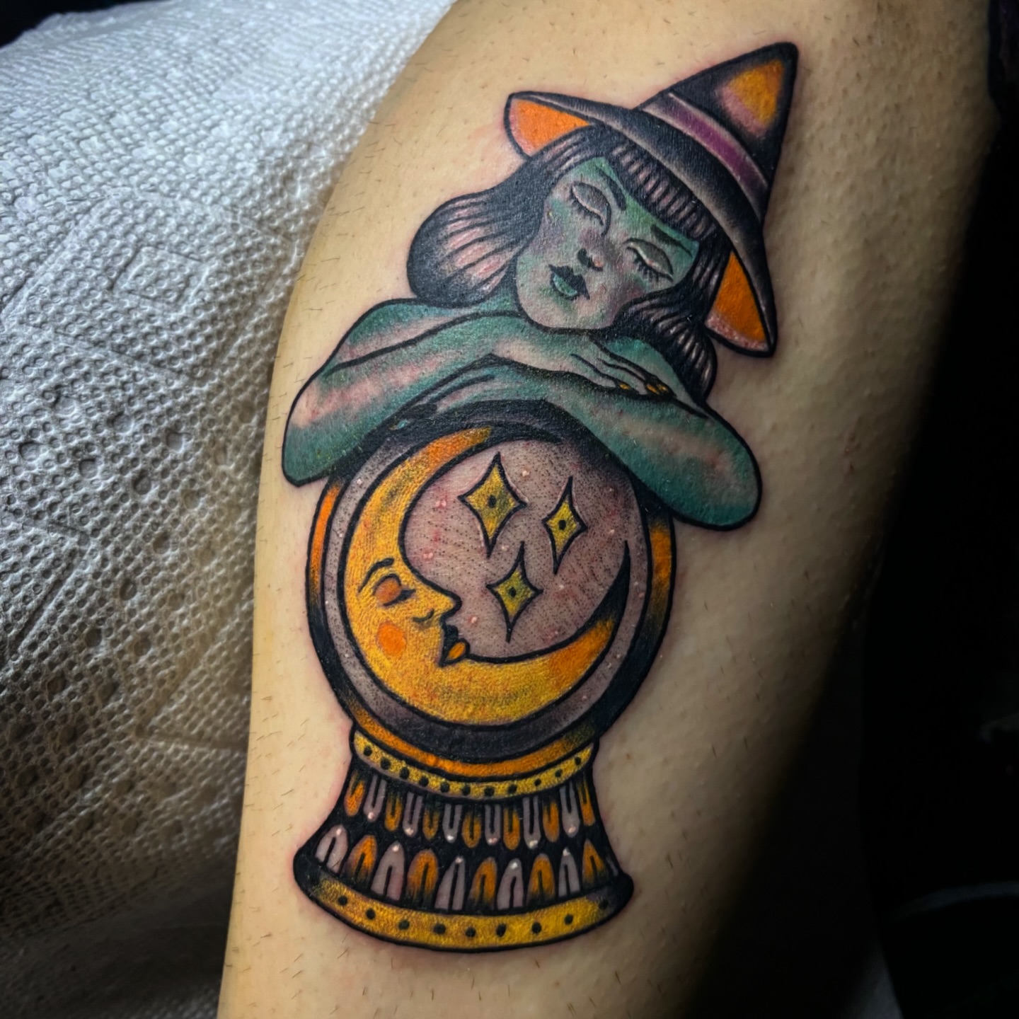 Witch and crystal ball American traditional tattoo on the thigh by Randi Frey