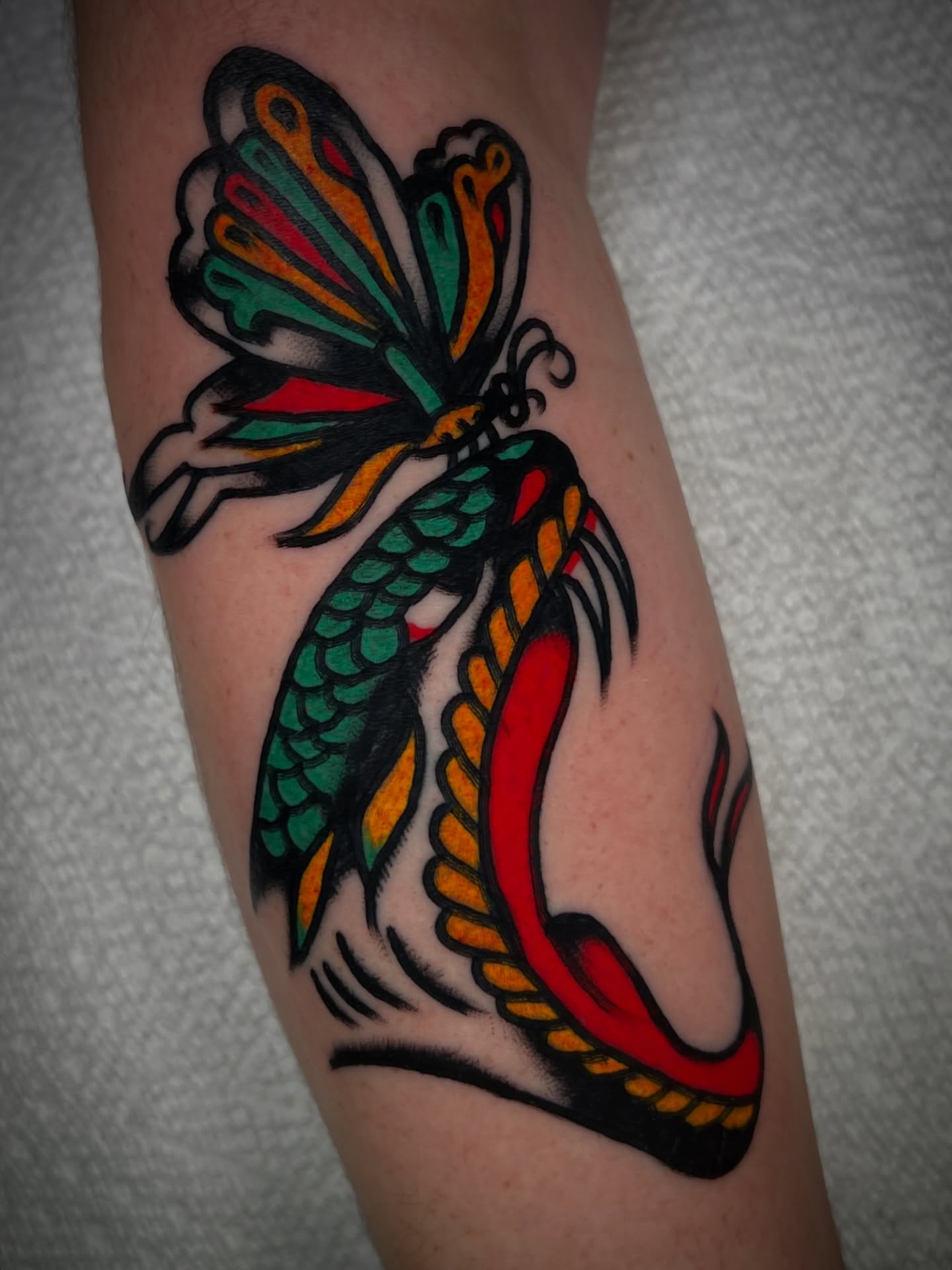 Dragon and butterfly American traditional tattoo on the forearm by 💥Jeff Klug💥, Austin, Texas