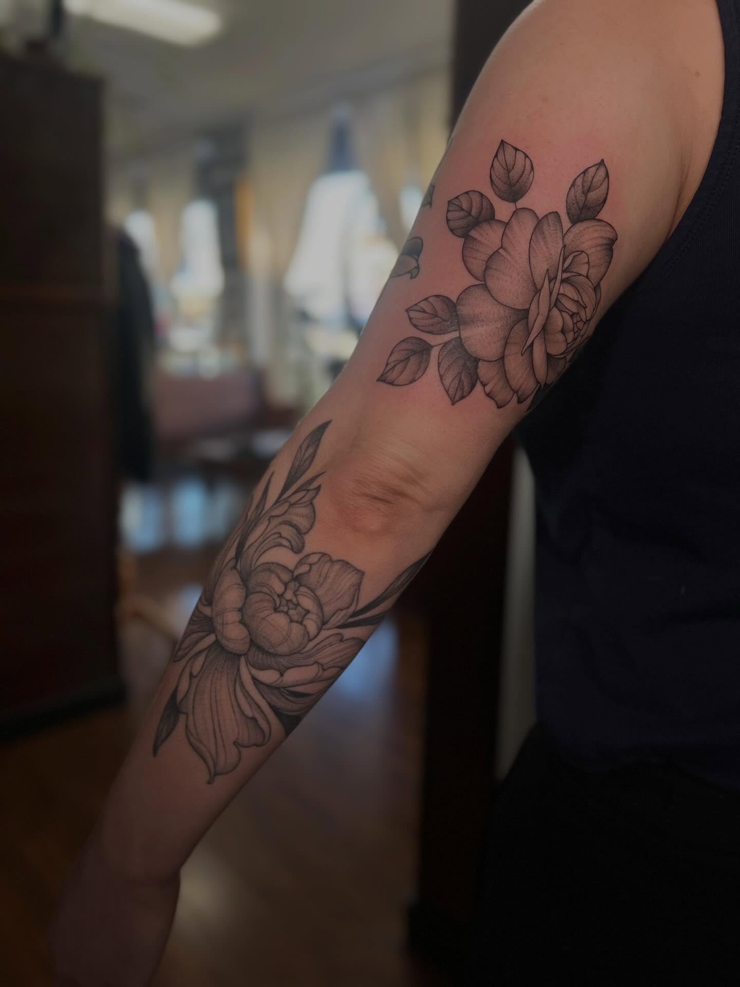 Floral bouquet black and grey tattoo on the forearm by Avrey Simone