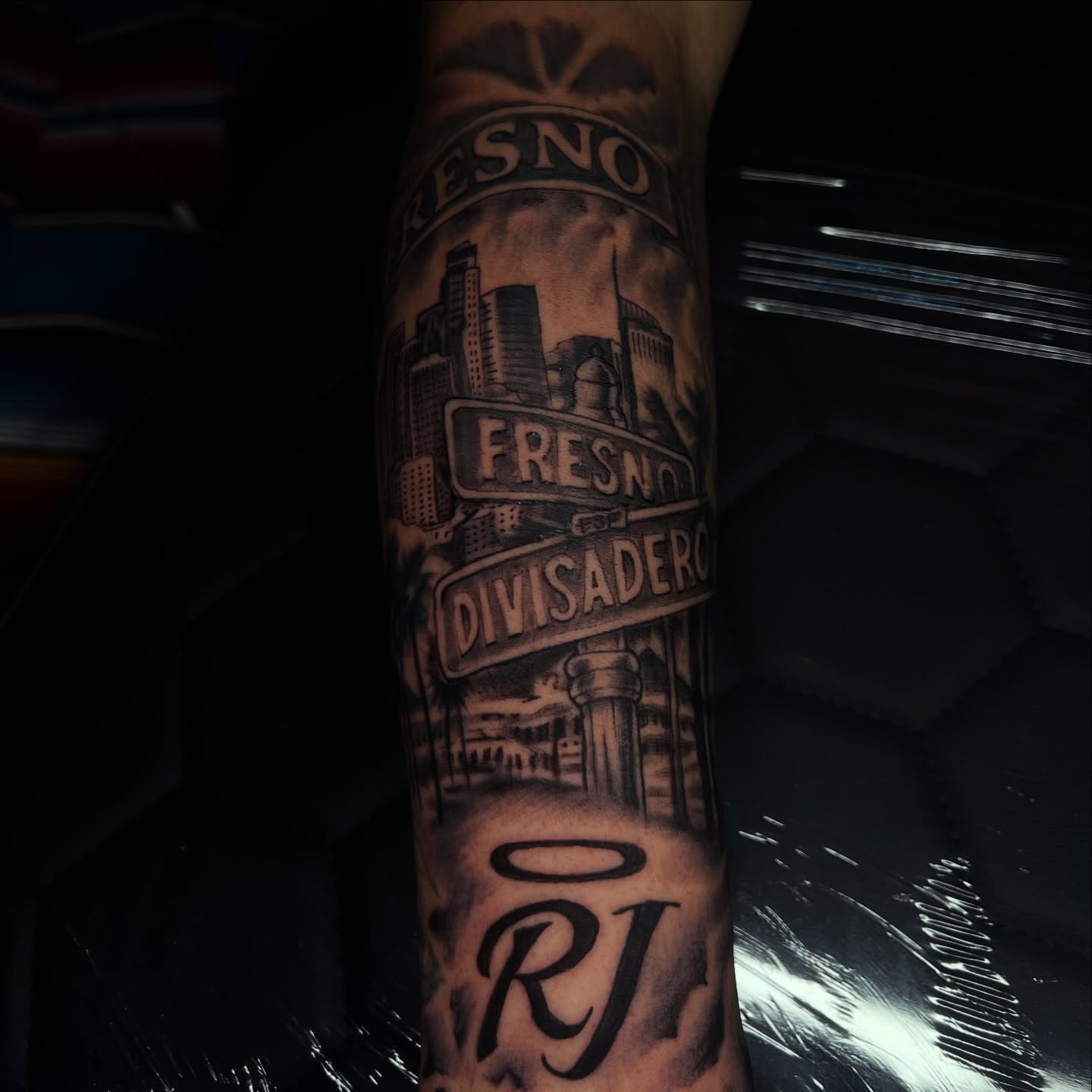 Cityscape black and grey tattoo on the forearm by Monstro Ink Arts Tattoos, Bakersfield, California