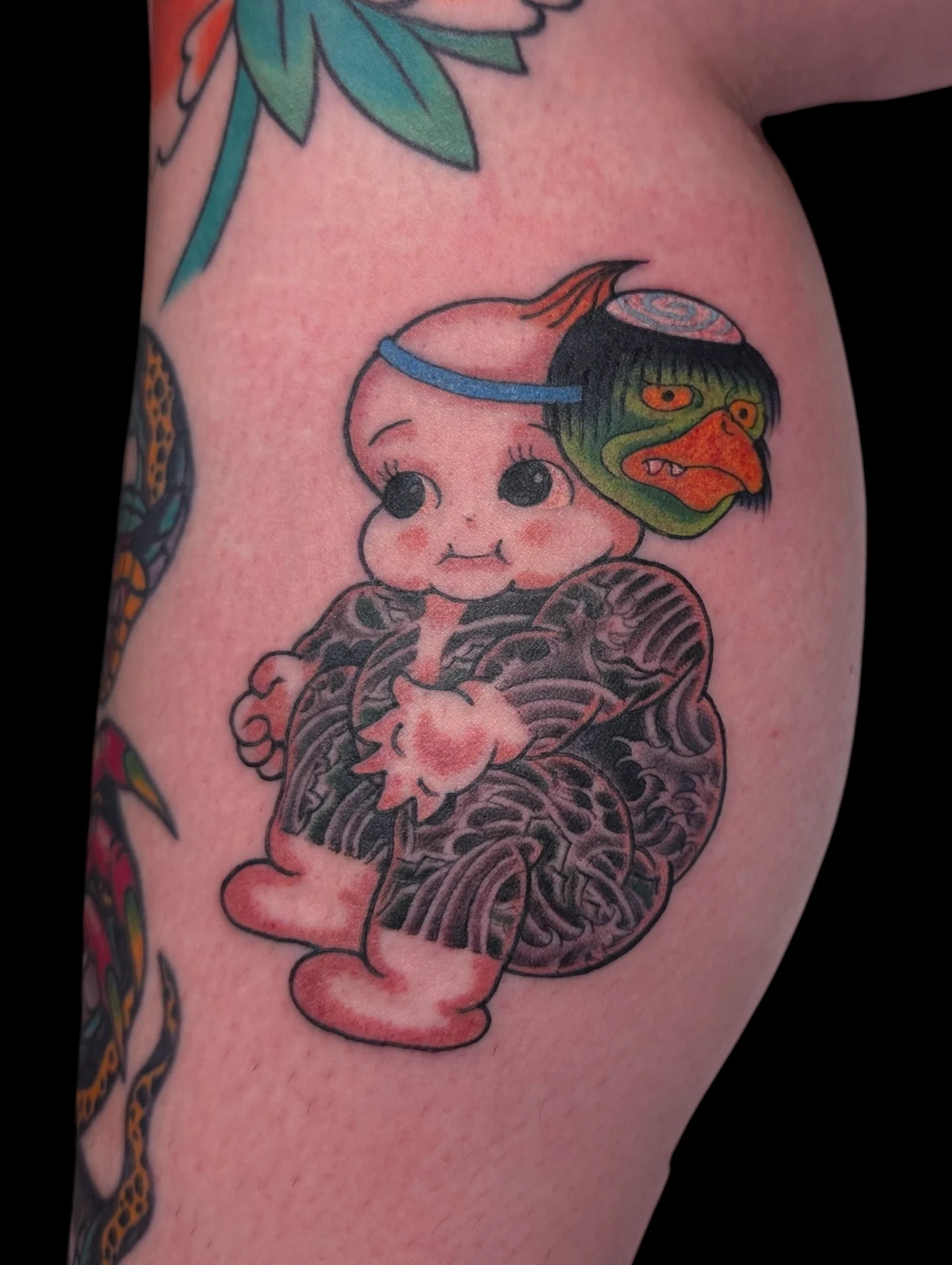 Kewpie doll new school tattoo on the thigh by Angela Mukai