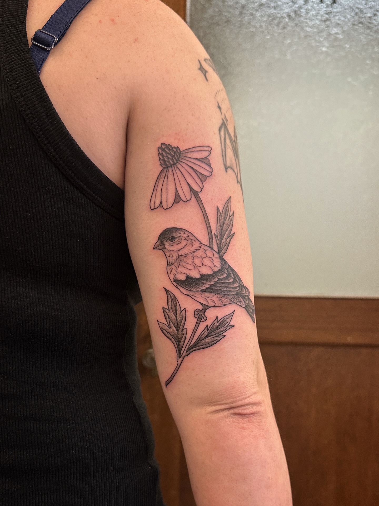 Bird and flower black and grey tattoo on the forearm by Tattooing by Patty Valentine
