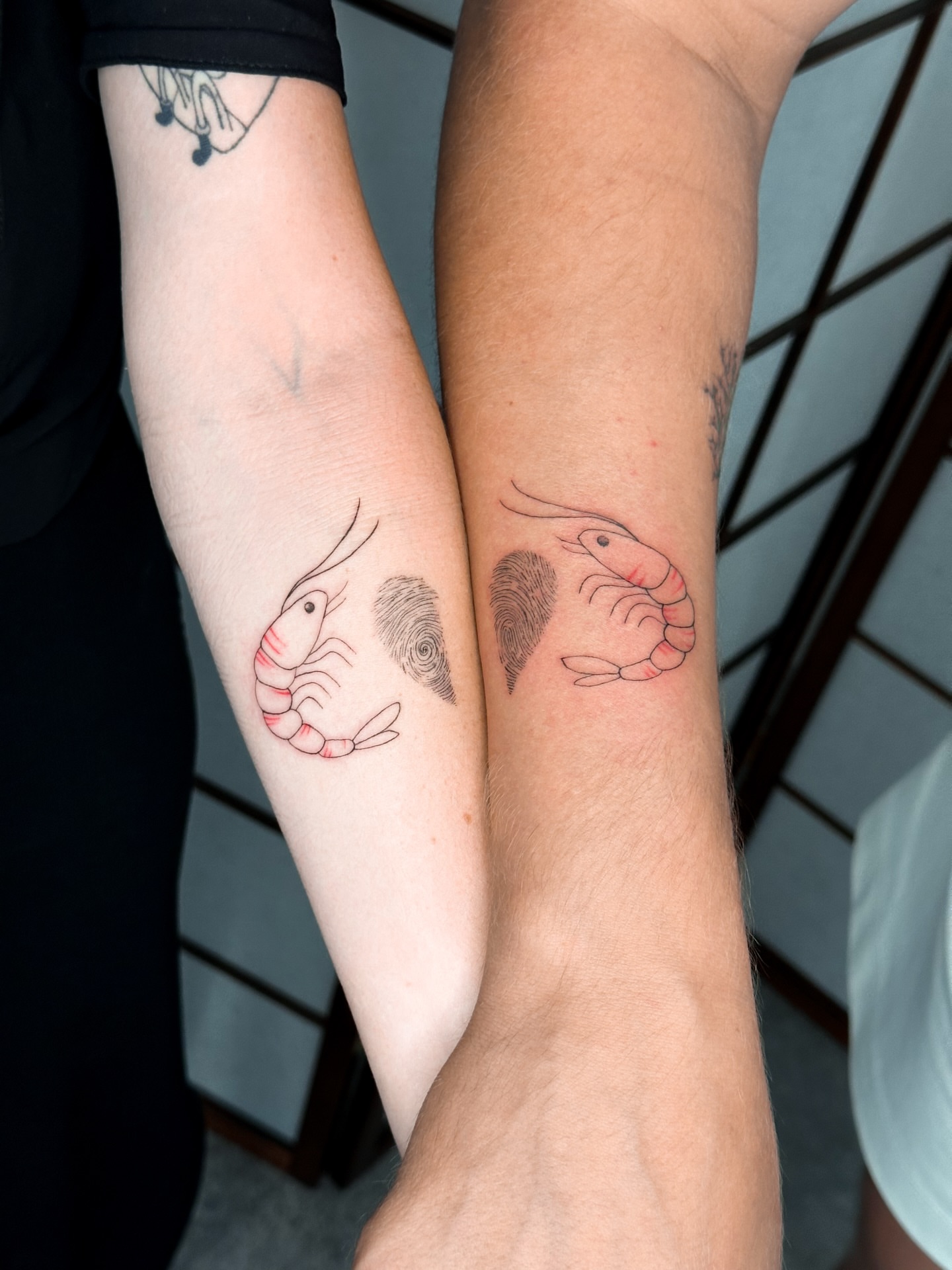Prawn and fingerprint dotwork tattoo on the forearm by Mila, Riga, Latvia
