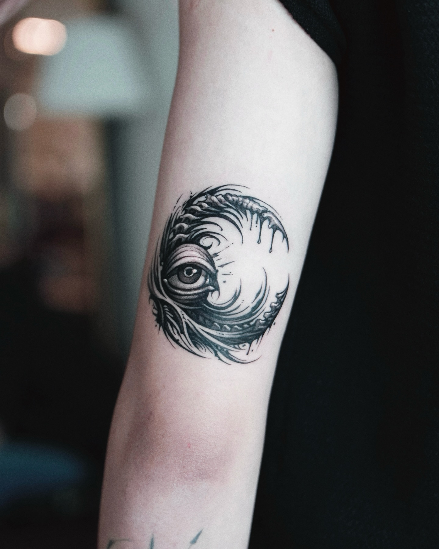 Eye within swirling pattern realism tattoo on the forearm by 두식
