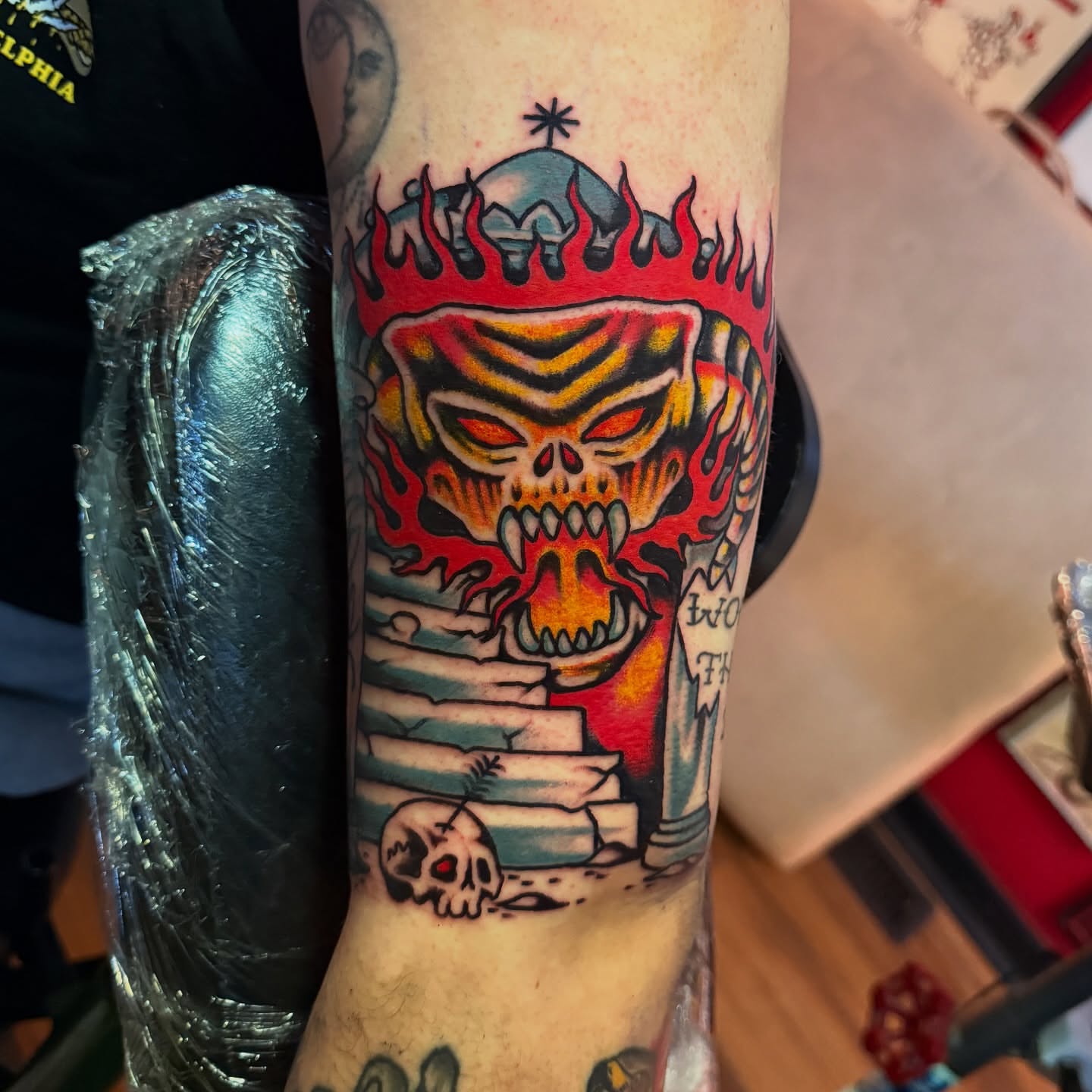 Flaming skull American traditional tattoo on the forearm by Angus Perfect, Philadelphia, Pennsylvania
