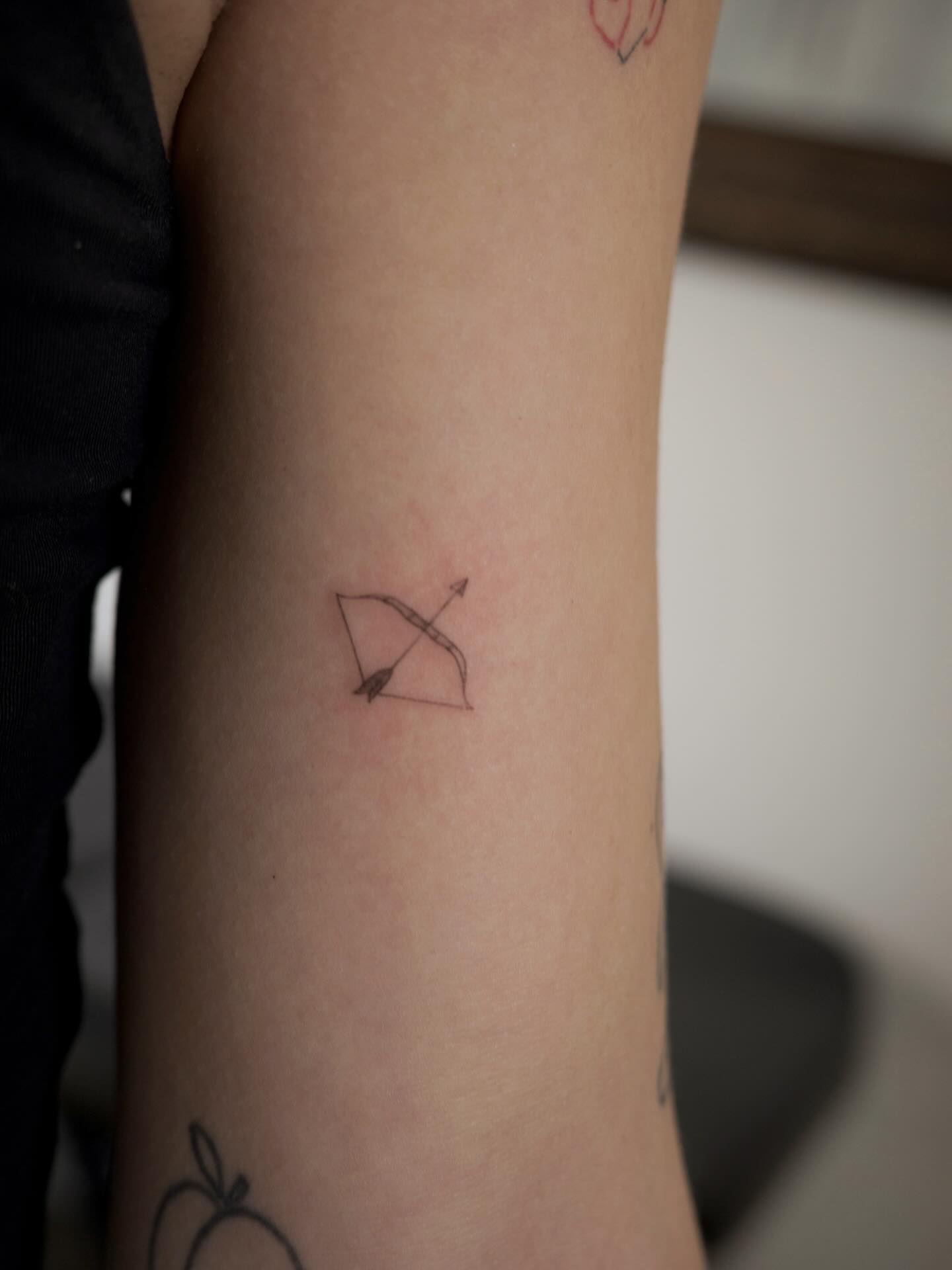 Bow and arrow geometric tattoo on the forearm by It’s ya girl, KB