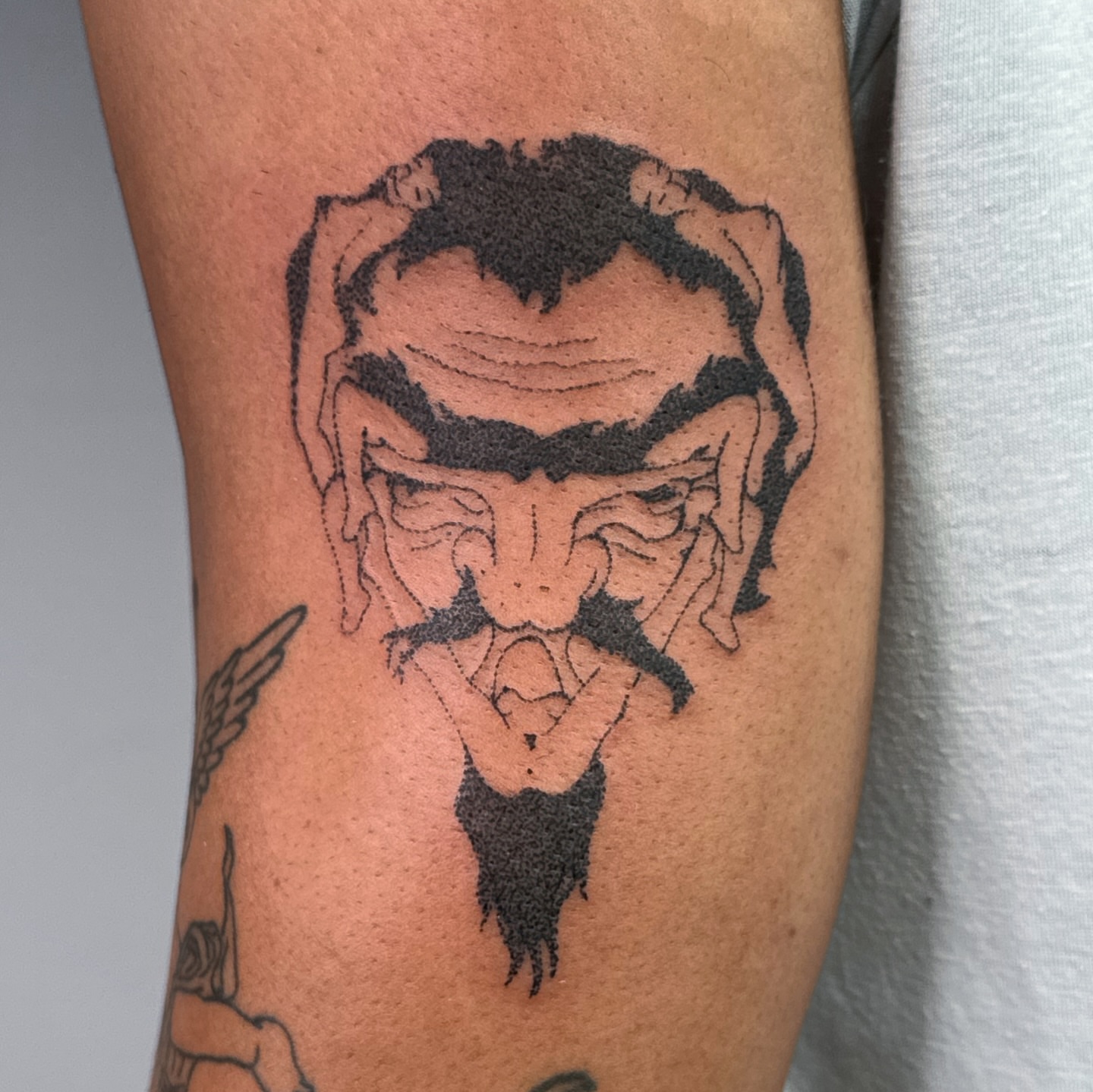 Demon face black and grey tattoo on the forearm by Joint Killer
