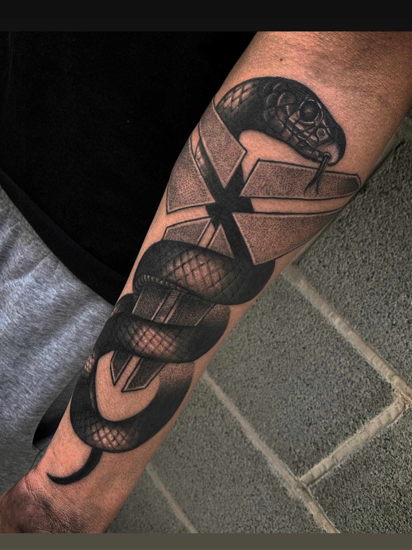 Snake geometric tattoo on the forearm by Javier Rivera