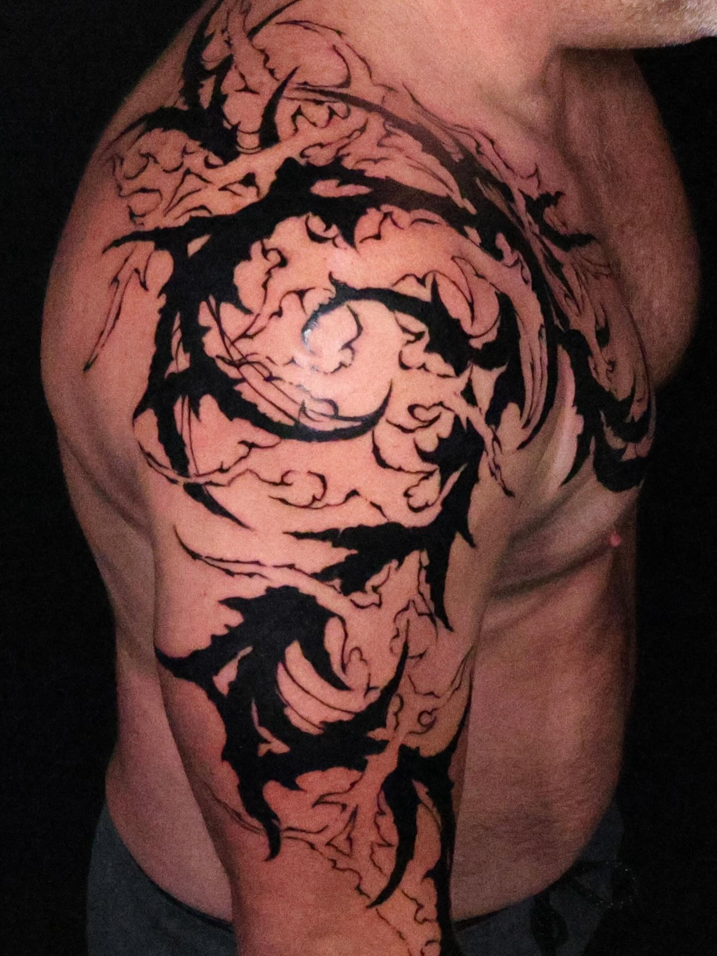 Abstract swirl black and grey tattoo on the shoulder by Troy Butner