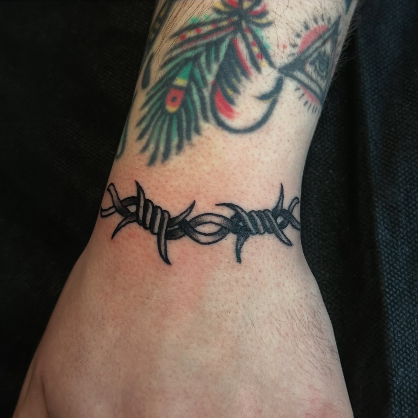Barbed wire black and grey tattoo on the forearm by Victoria