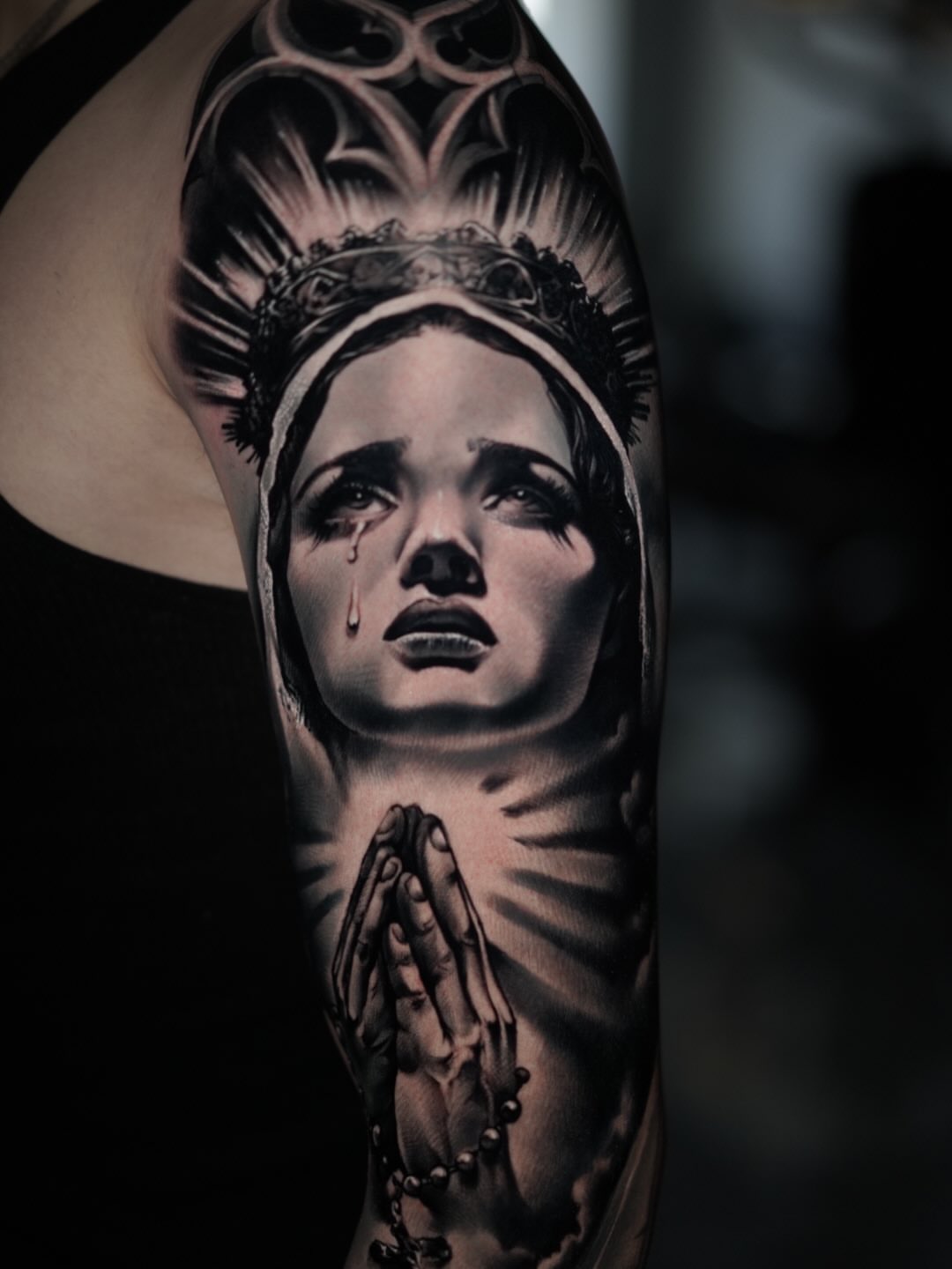 Praying woman dark realism tattoo on the forearm by Angel Perez