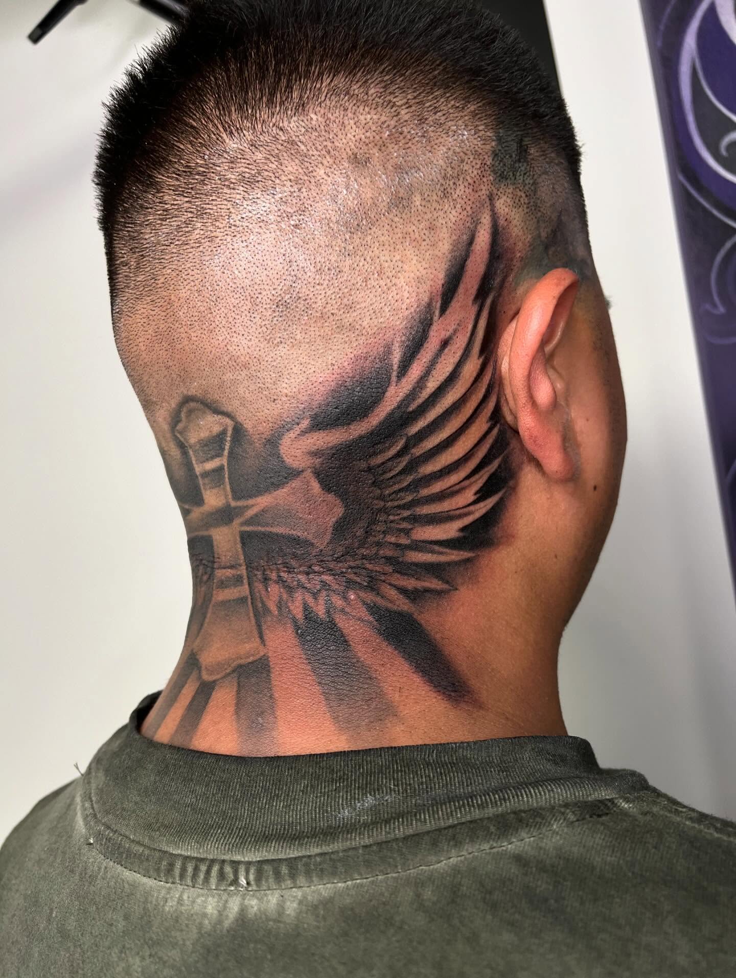 Cross and wings black and grey tattoo on the neck by San Diego Fineline Black & Grey Tattoo Artist
