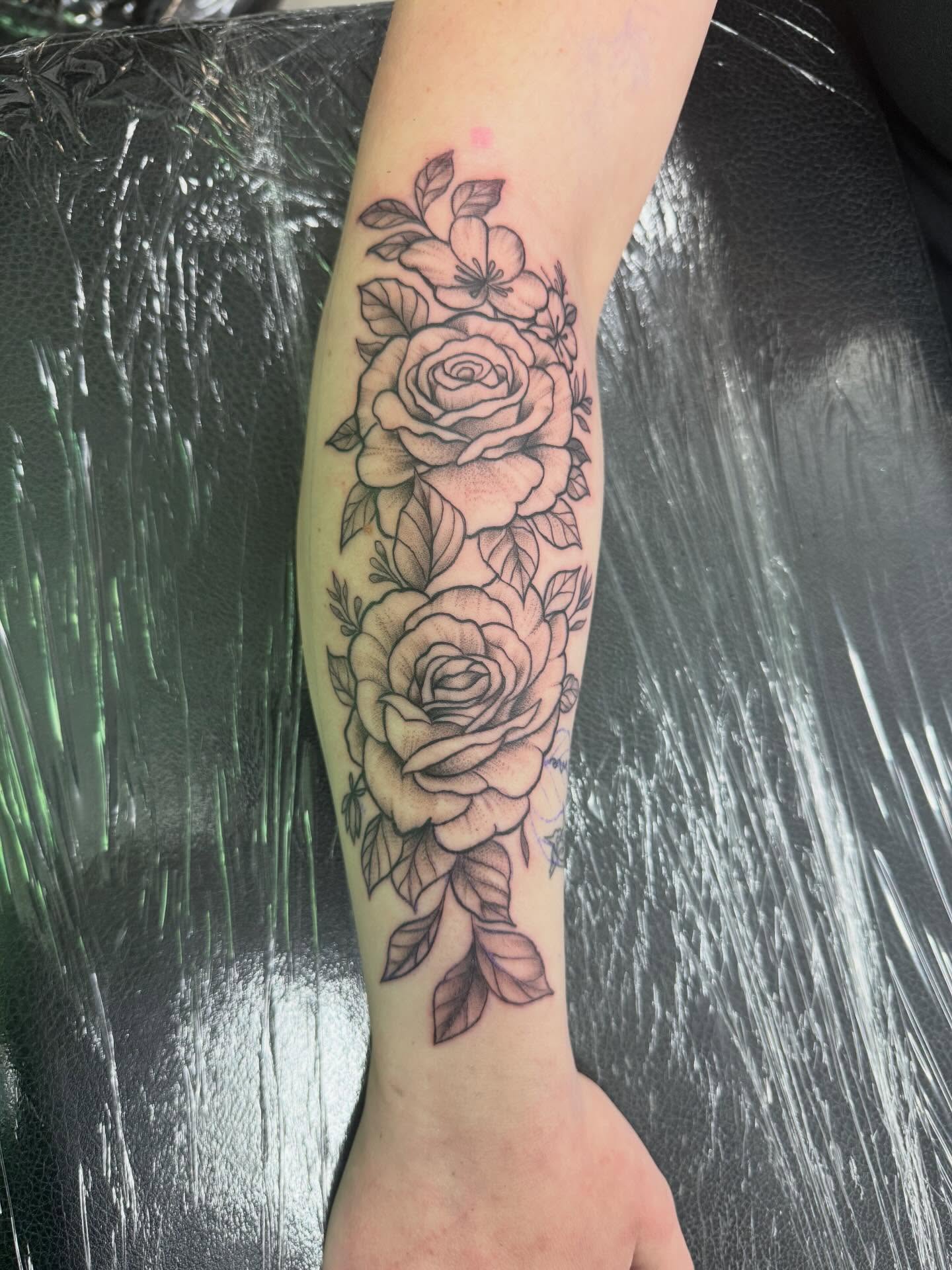 Roses black and grey tattoo on the forearm by Daniel Smith