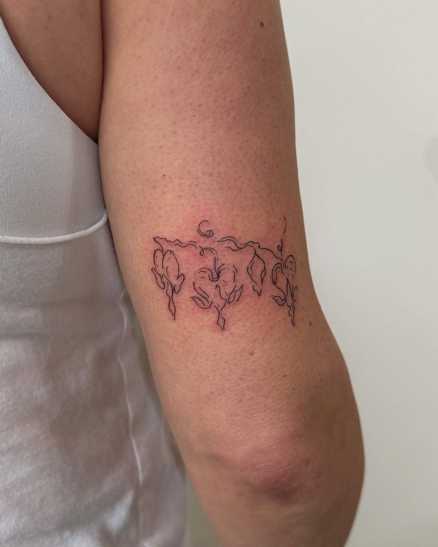 Floral design fine line tattoo on the forearm by Inky Apricot, Austin, Texas