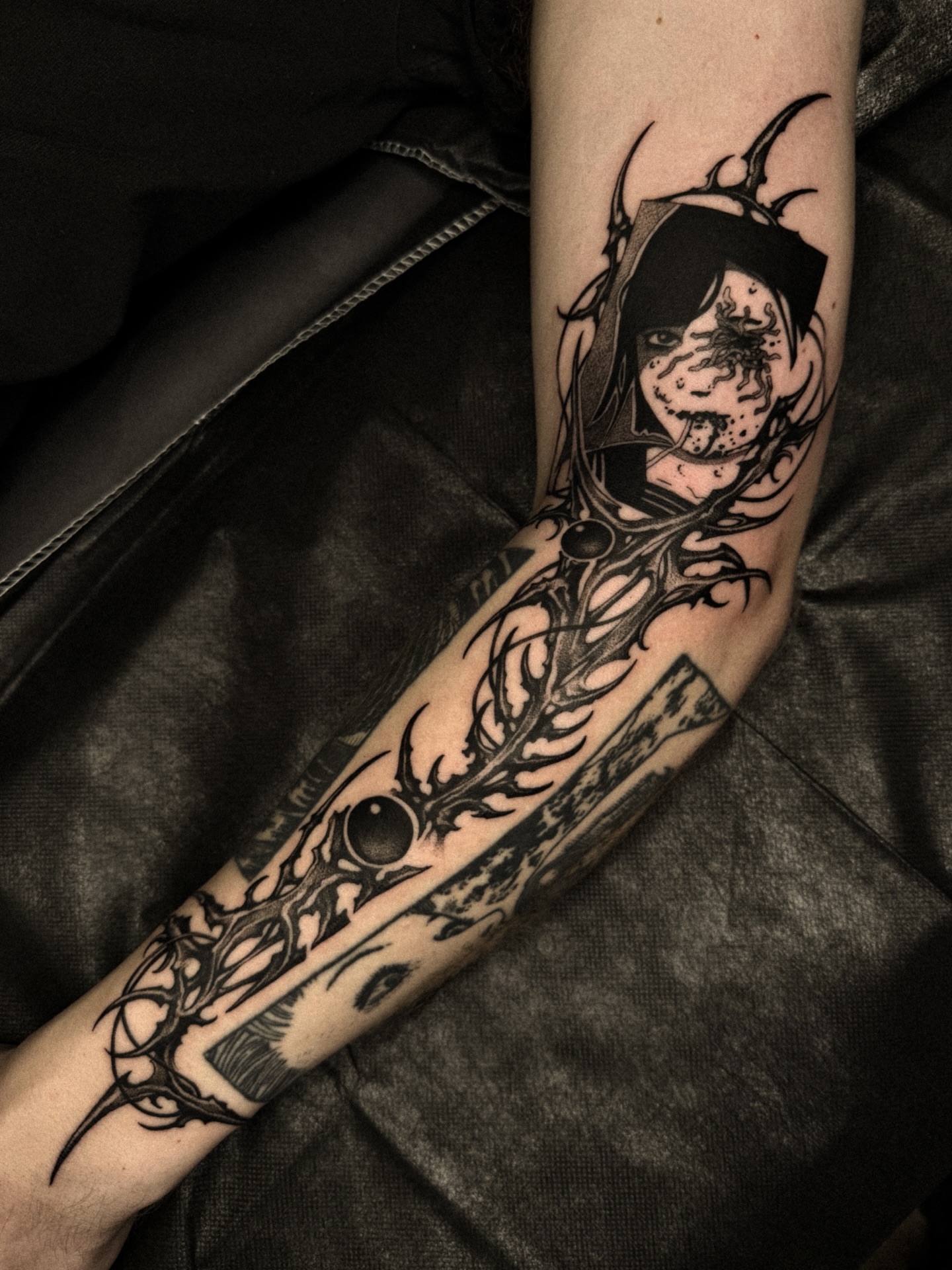 Hooded figure dark realism tattoo on the forearm by David Ha
