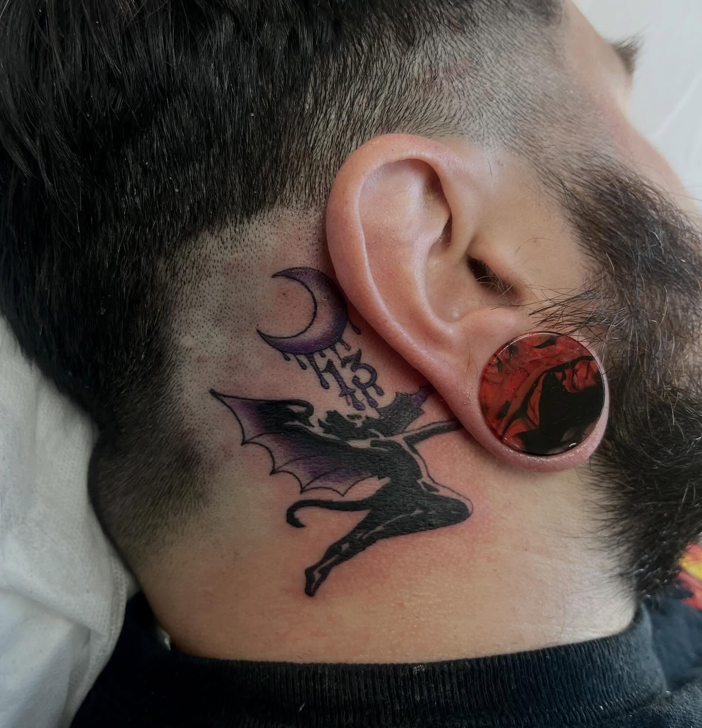 Bat silhouette American traditional tattoo on the neck by Brooke Kresco