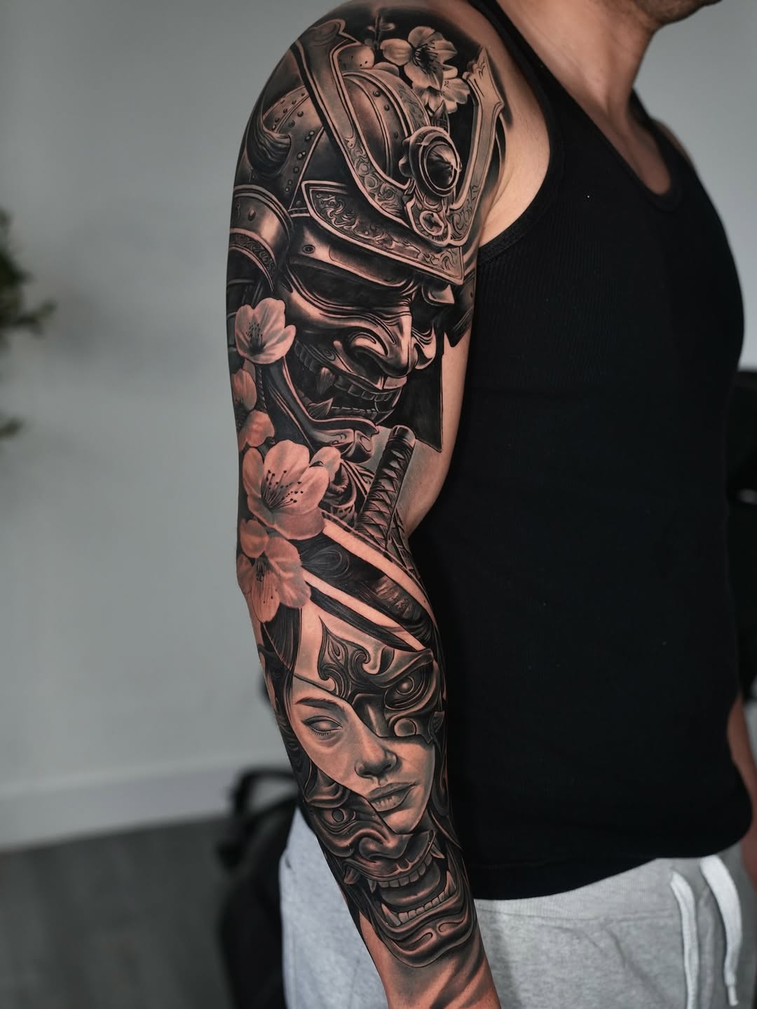 Samurai mask and geisha Japanese tattoo on the upper arm by Luis Manuel Olivera, North Miami, Florida