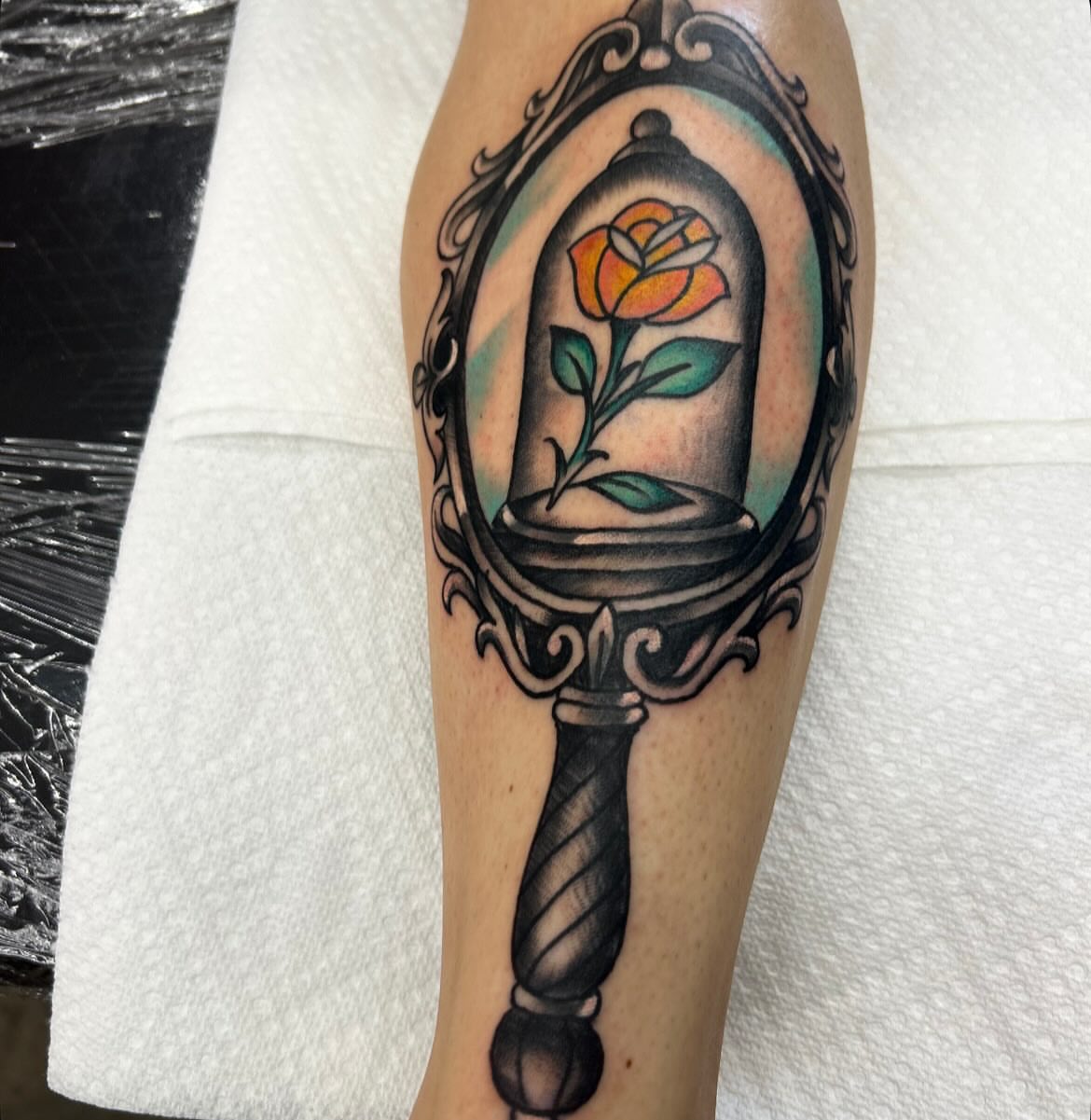 Rose in glass bell American traditional tattoo on the forearm by Dylan O'Quin
