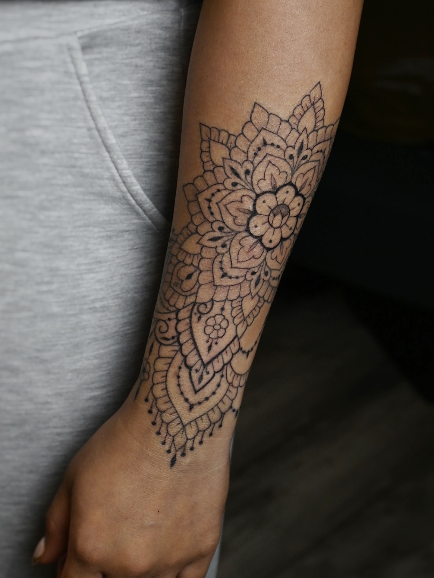 Mandala black and grey tattoo on the forearm by Sabreena Haque