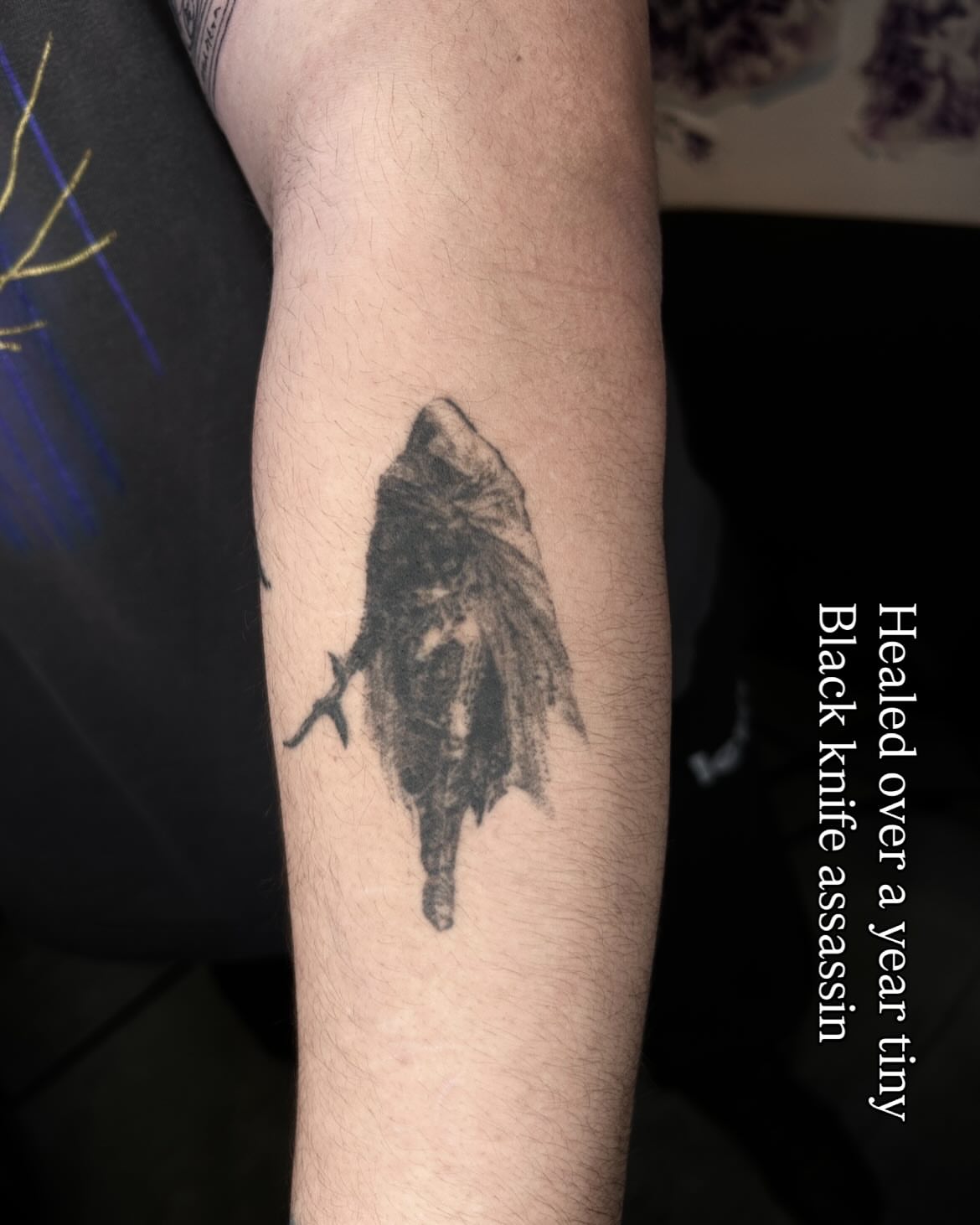 Black knife assassin black and grey tattoo on the forearm by ๐๐ฆ๐ฐ๐ฆ๐