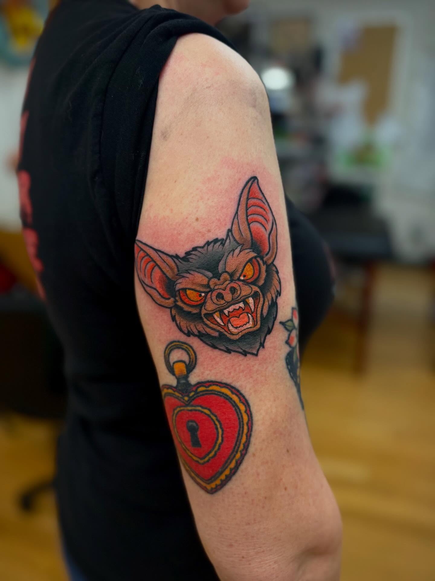 Bat and heart American traditional tattoo on the forearm by Tyler Harrington