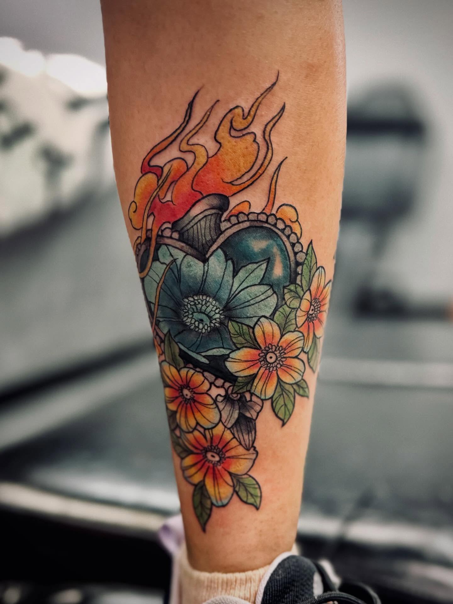 Floral heart with flames new school tattoo on the forearm by Katelyn Arnold