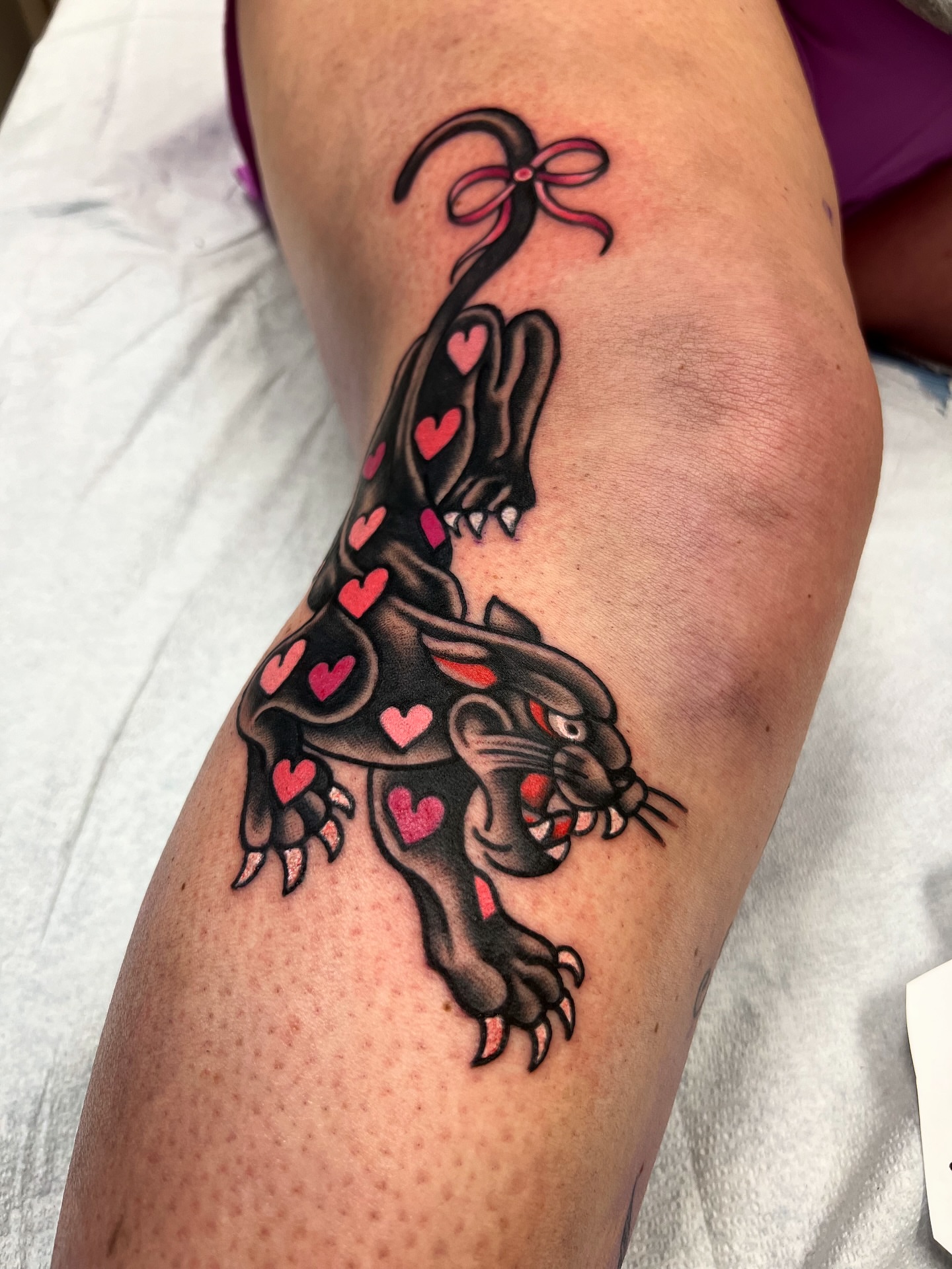 Panther with hearts American traditional tattoo on the thigh by Shannon Pagliarini