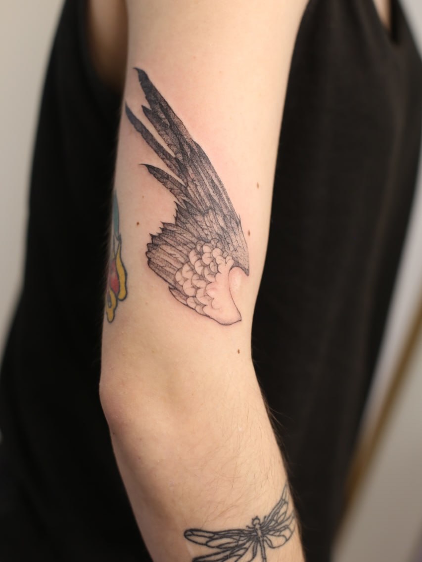 Bird wing black and grey tattoo on the forearm by Inna Petrova, Kitchener, Ontario