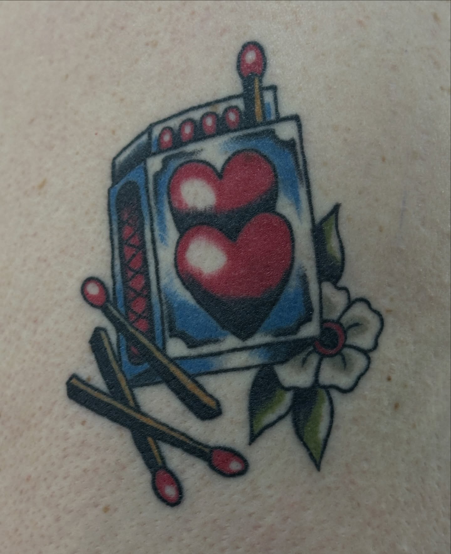 Playing card with hearts American traditional tattoo on the forearm by julian solis, Houston, Texas