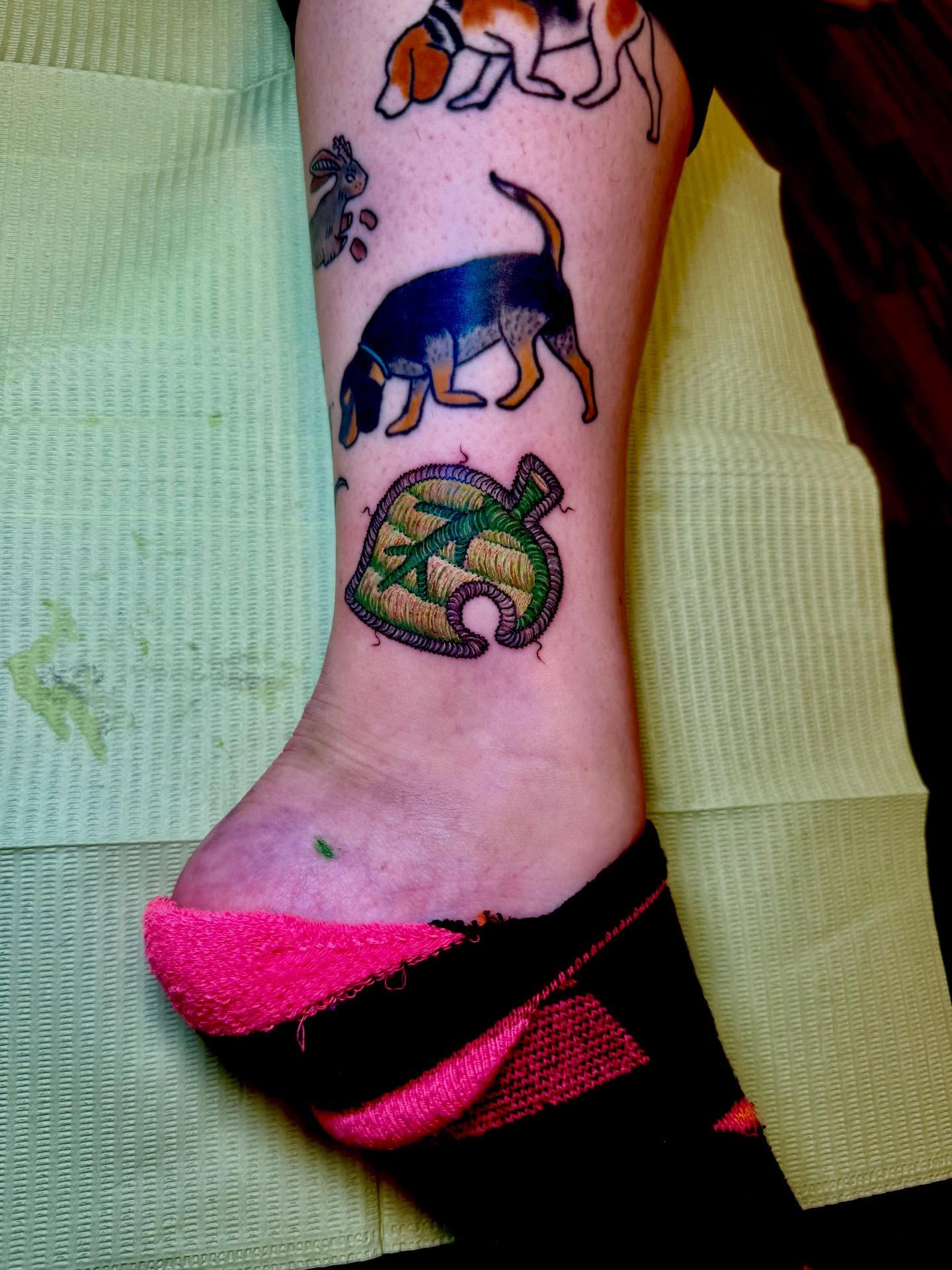 Dogs and leaf American traditional tattoo on the foot by Max