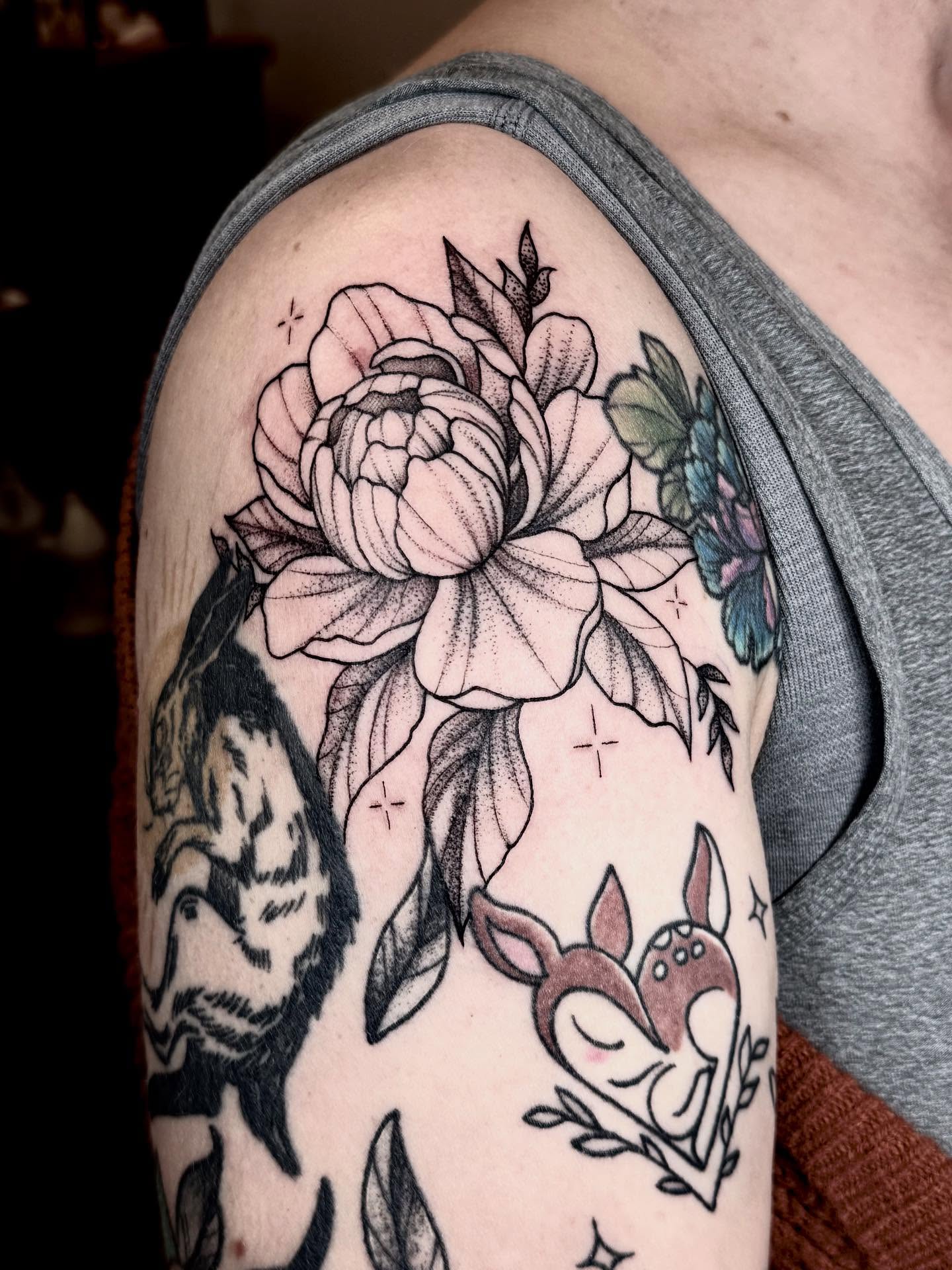 Peony and fox black and grey tattoo on the upper arm by Max