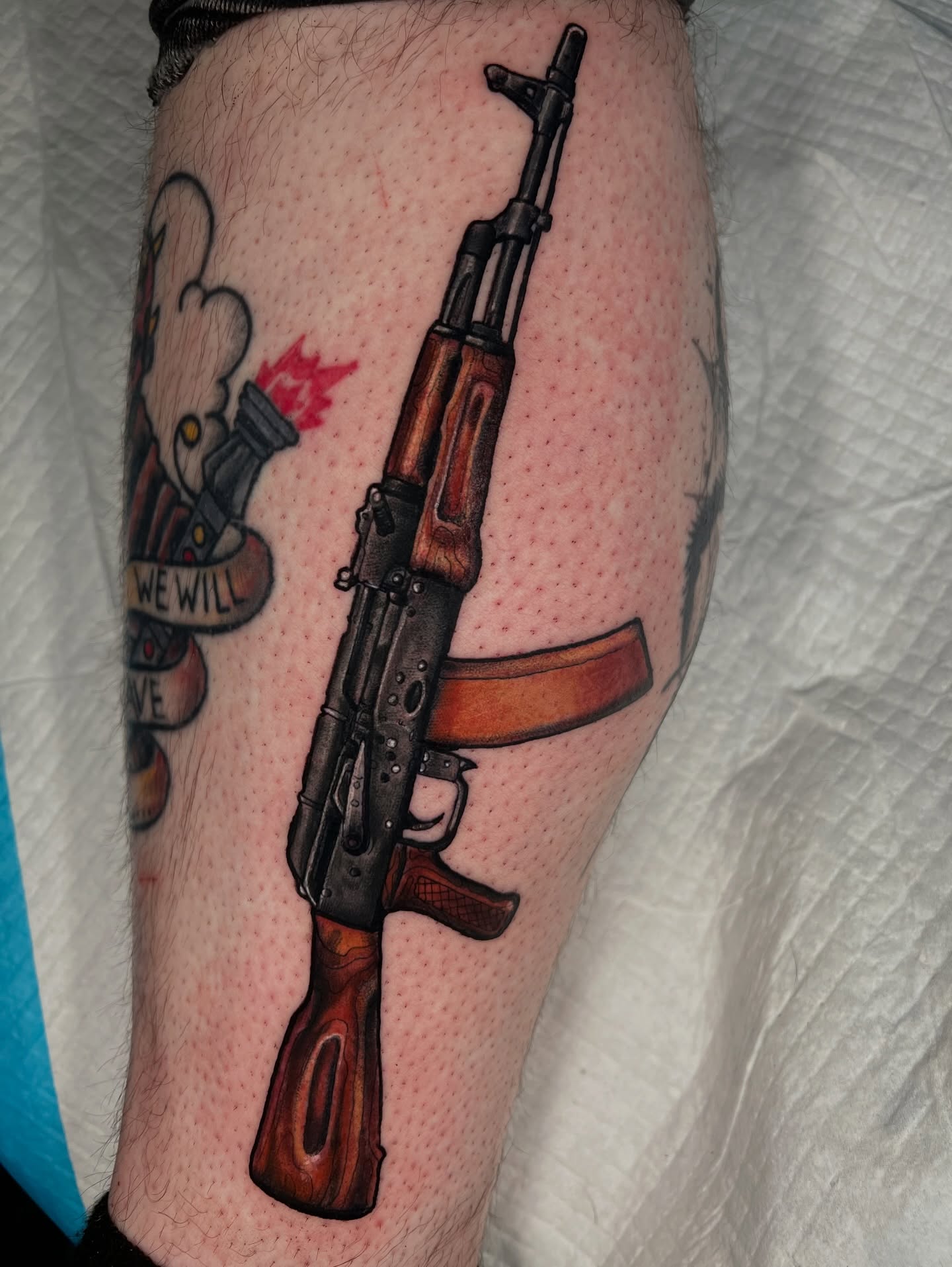 Ak-47 rifle realism tattoo on the forearm by Brandon Durbin