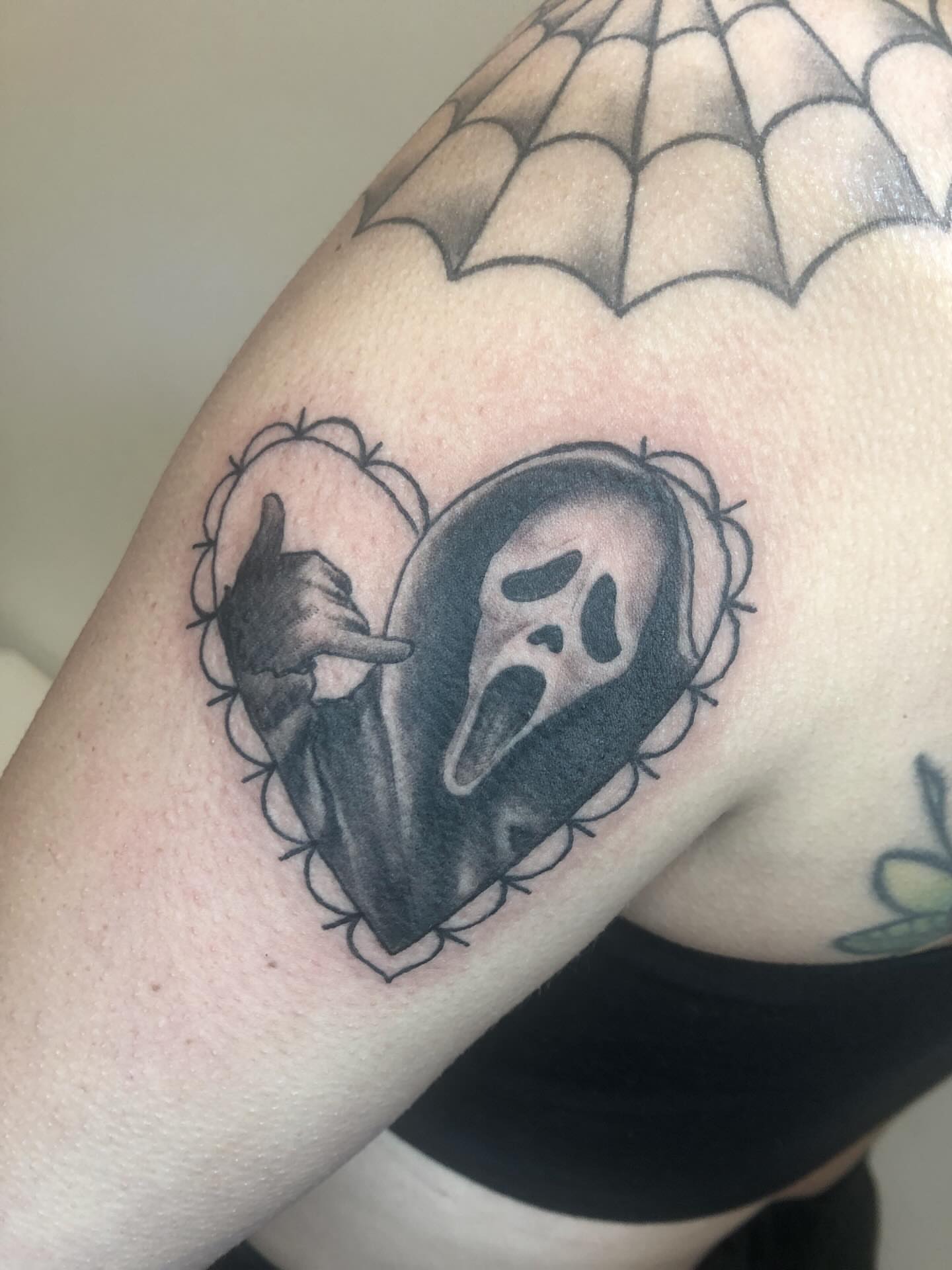 Ghost mask black and grey tattoo on the shoulder by Cassandra Colleen