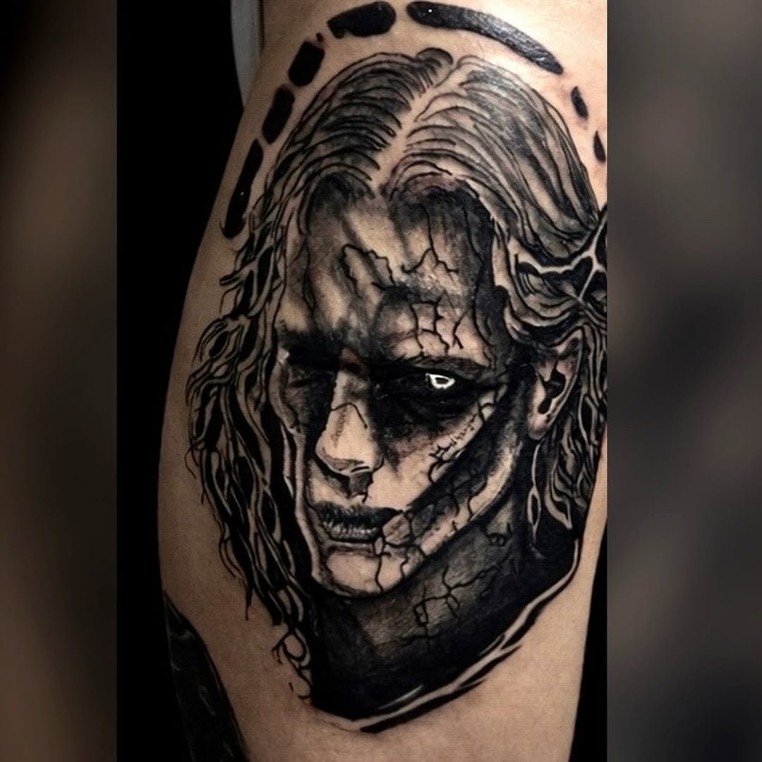 Cracked face portrait realism tattoo on the upper arm by K Valentine