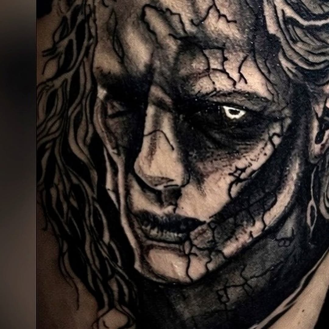 Cracked face portrait dark art tattoo on the chest by K Valentine