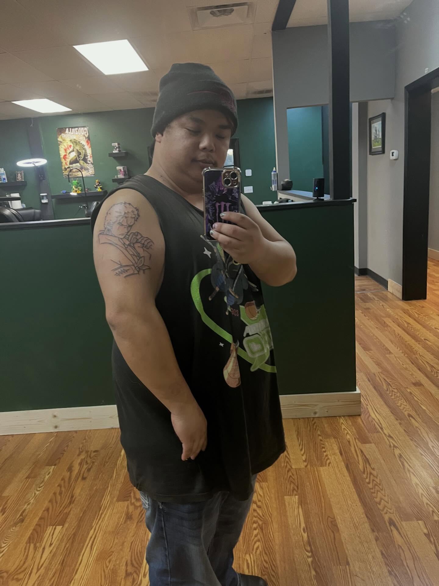 Man with tattoo American traditional tattoo on the upper arm by joshua sides