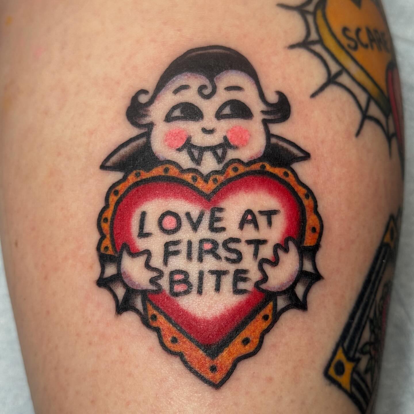 Love at first bite American traditional tattoo on the thigh by JoJo Benton