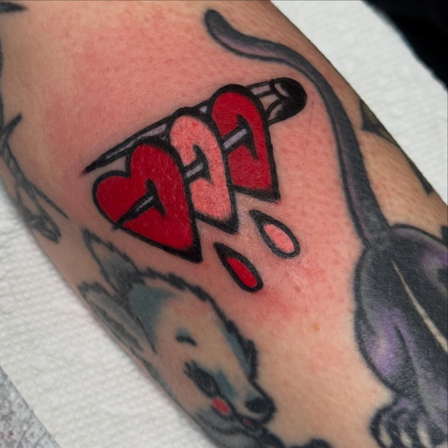 Heart with exclamation marks American traditional tattoo on the forearm by JoJo Benton