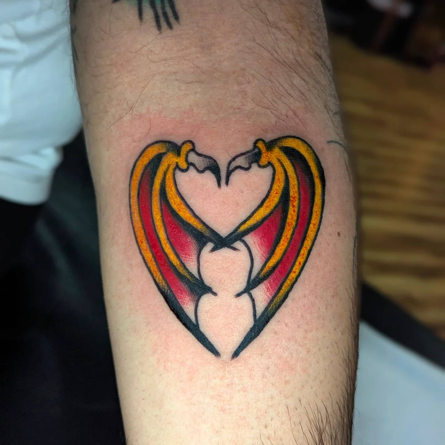 Heart with crossed swords geometric tattoo on the forearm by Eric Ward
