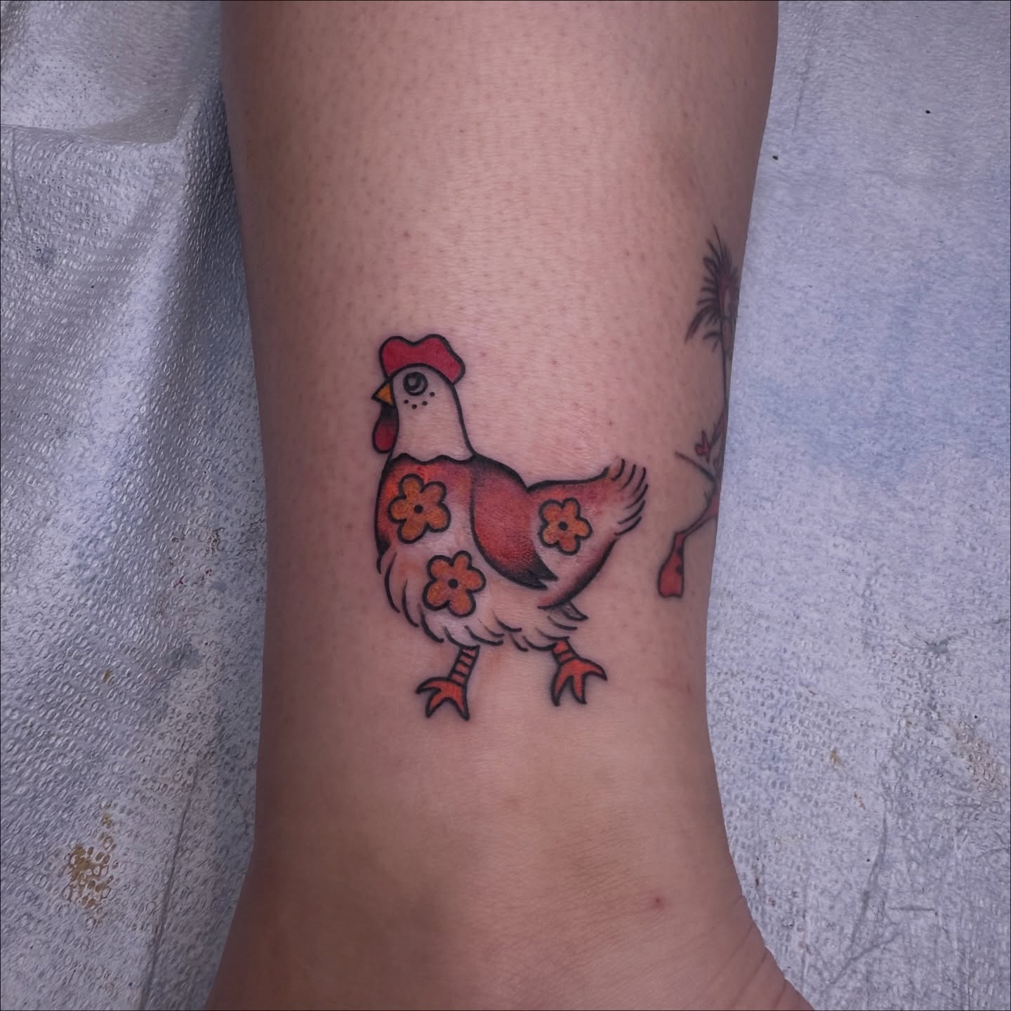 Chicken American traditional tattoo on the forearm by Brieana Smith