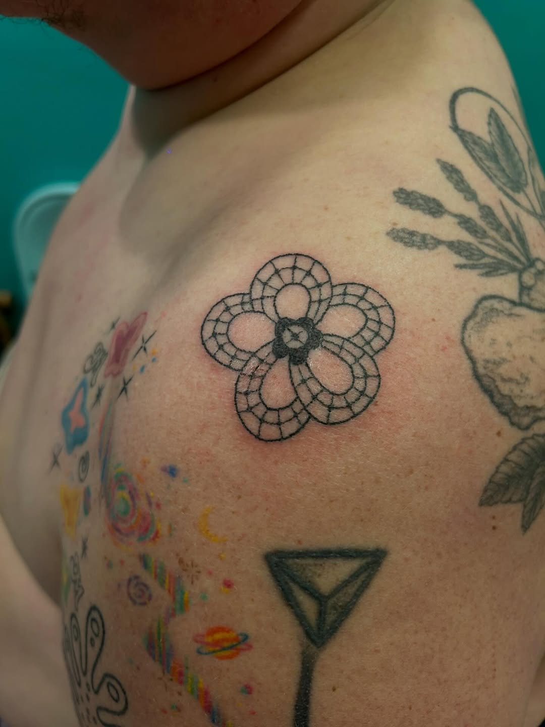 Flower geometric tattoo on the shoulder by Emma D