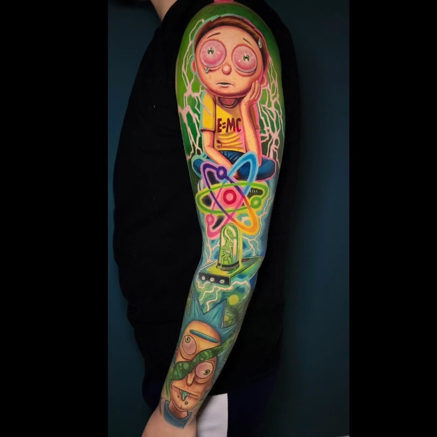 Atom and girl illustrative tattoo on the forearm by Melissa Does Tattoos - Bright, Bold Anime &