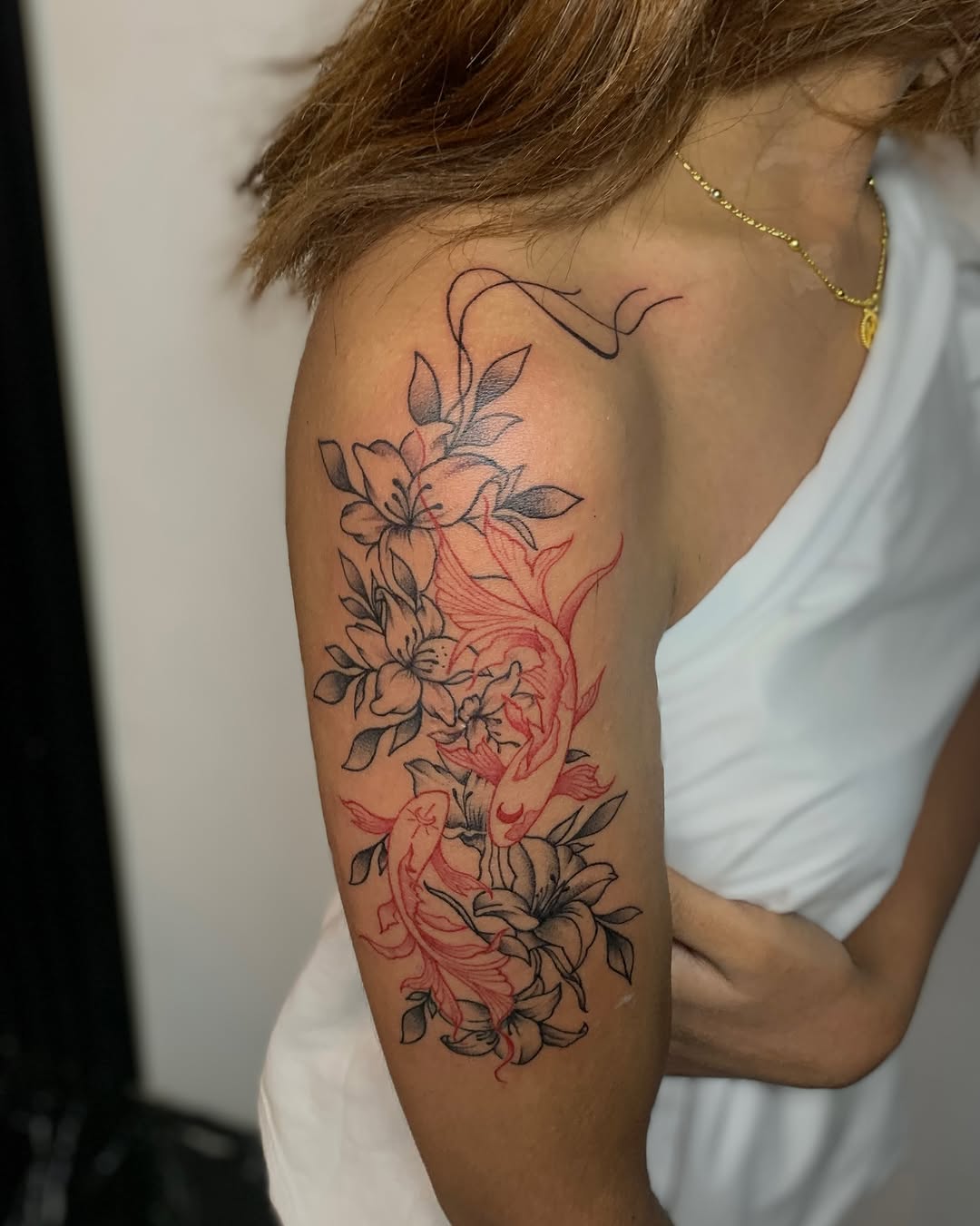 Koi fish and lilies Japanese tattoo on the upper arm by Gerd thINK_TATTOO