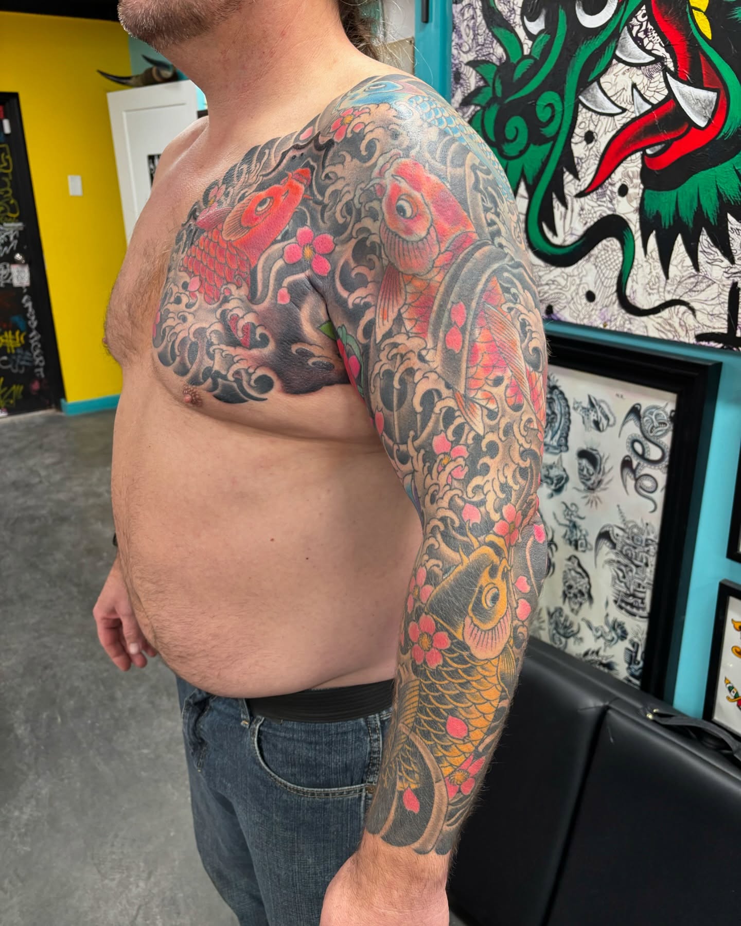 Koi fish and cherry blossoms japanese irezumi tattoo on the upper arm by Cody Wallenius, Merrillville, Indiana
